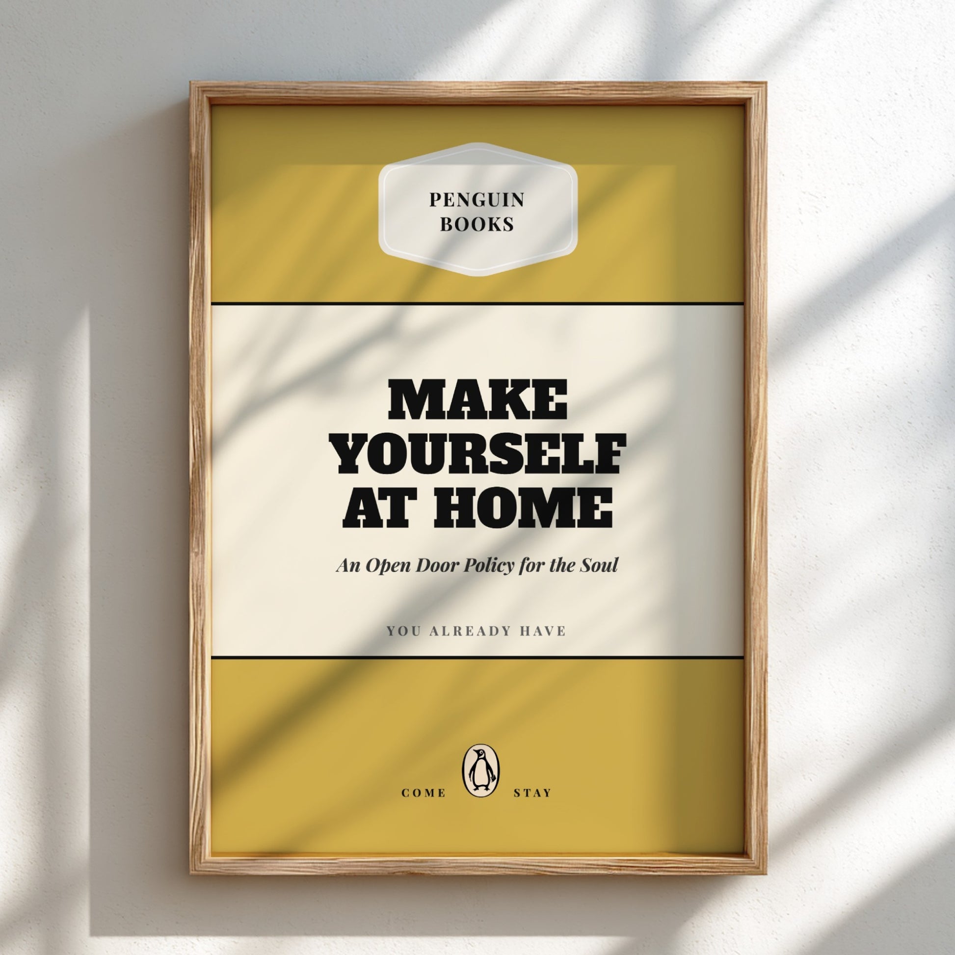 Framed Penguin Books poster with 'Make Yourself at Home' text on a light background
