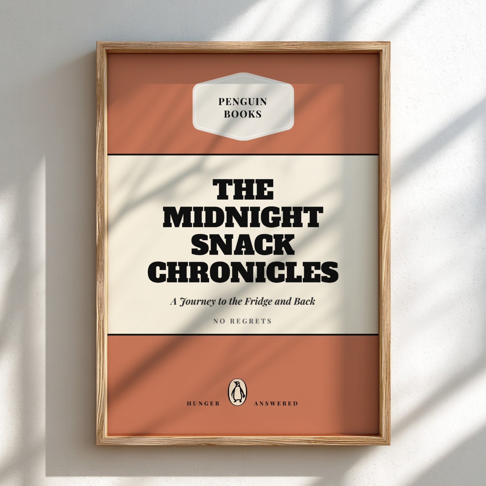 Framed book cover of 'The Midnight Snack Chronicles' by Penguin Books on a light background