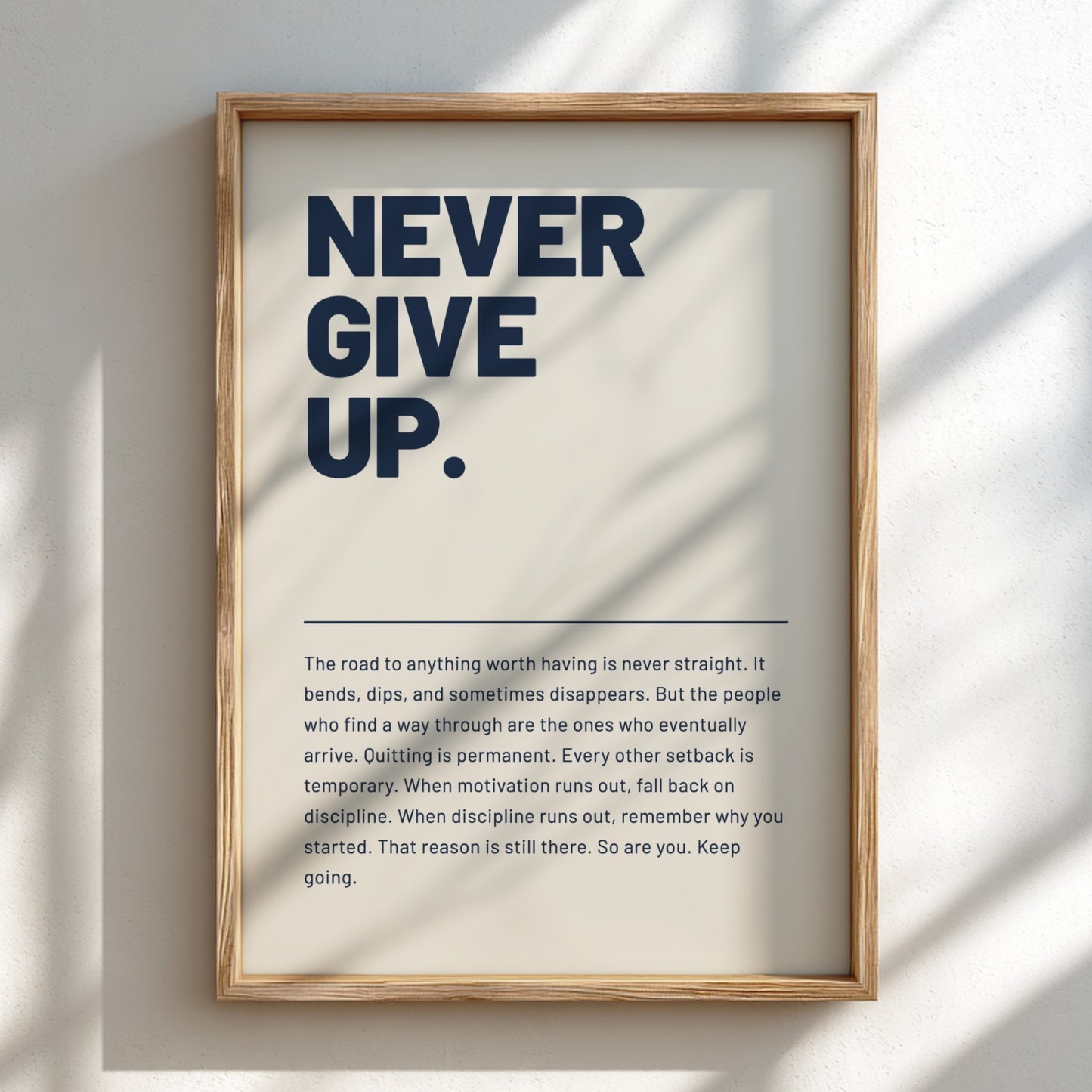 Framed motivational poster with 'Never Give Up.' text on a light background