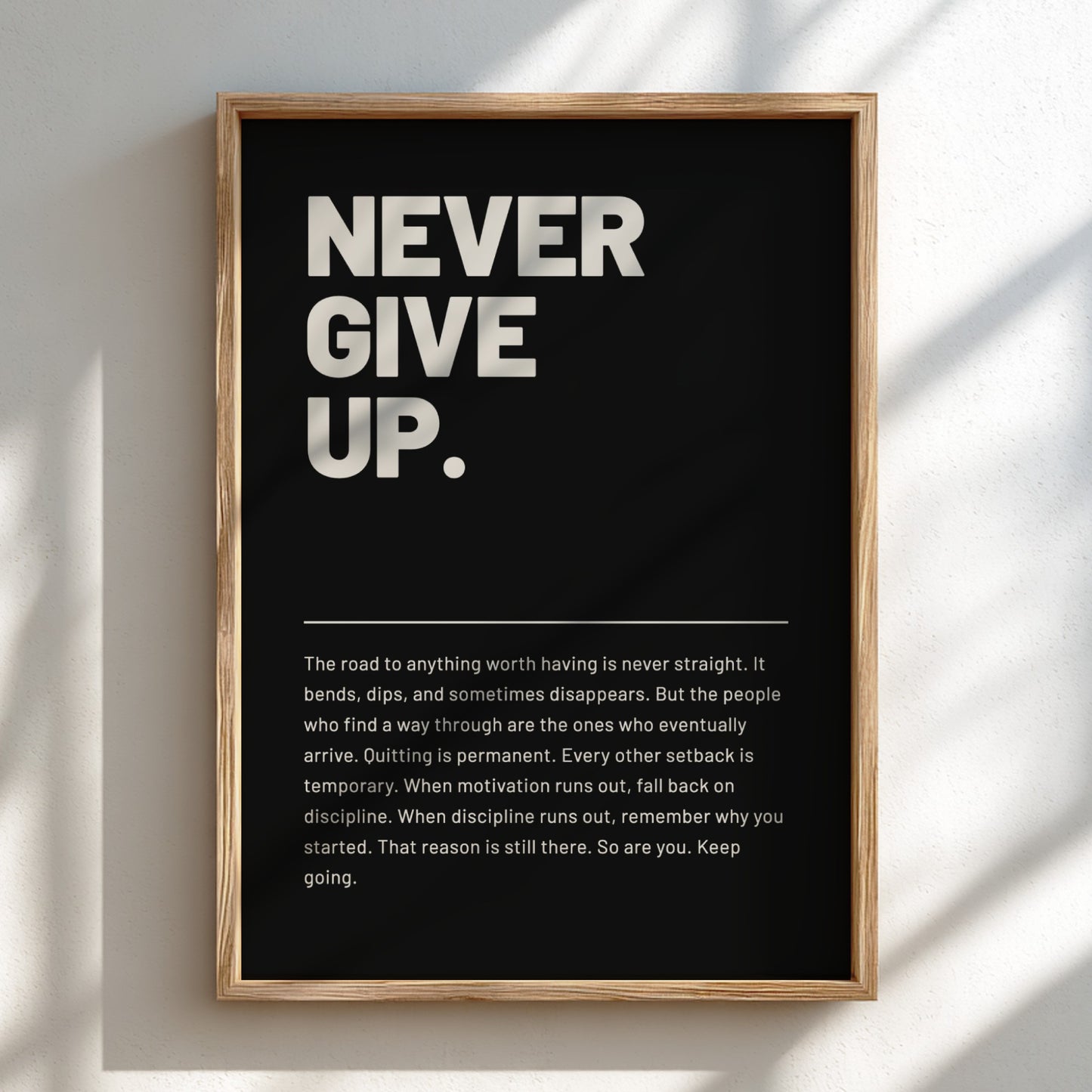 Framed poster with motivational quote 'Never Give Up' on a black background