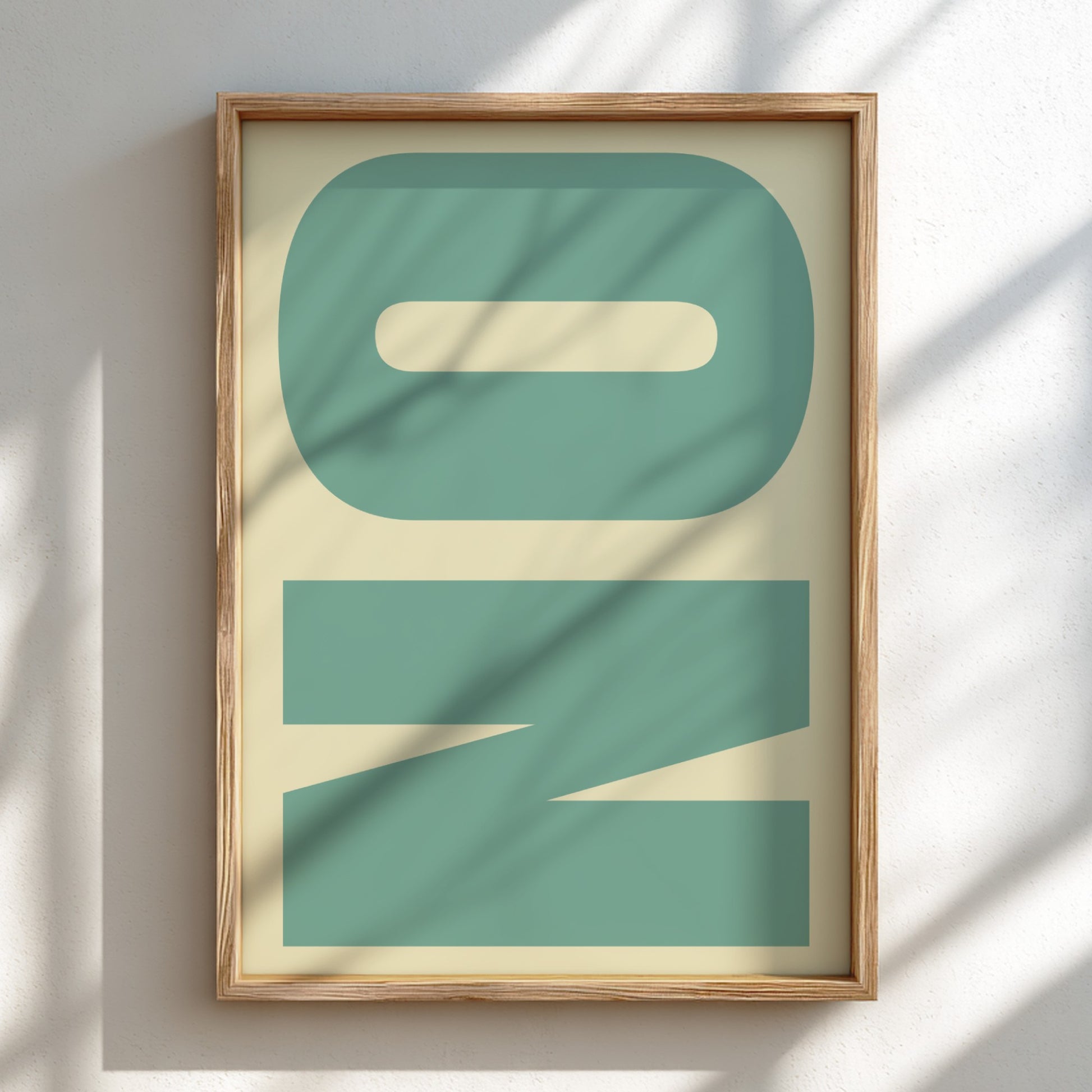 Framed artwork with abstract green design on a light background