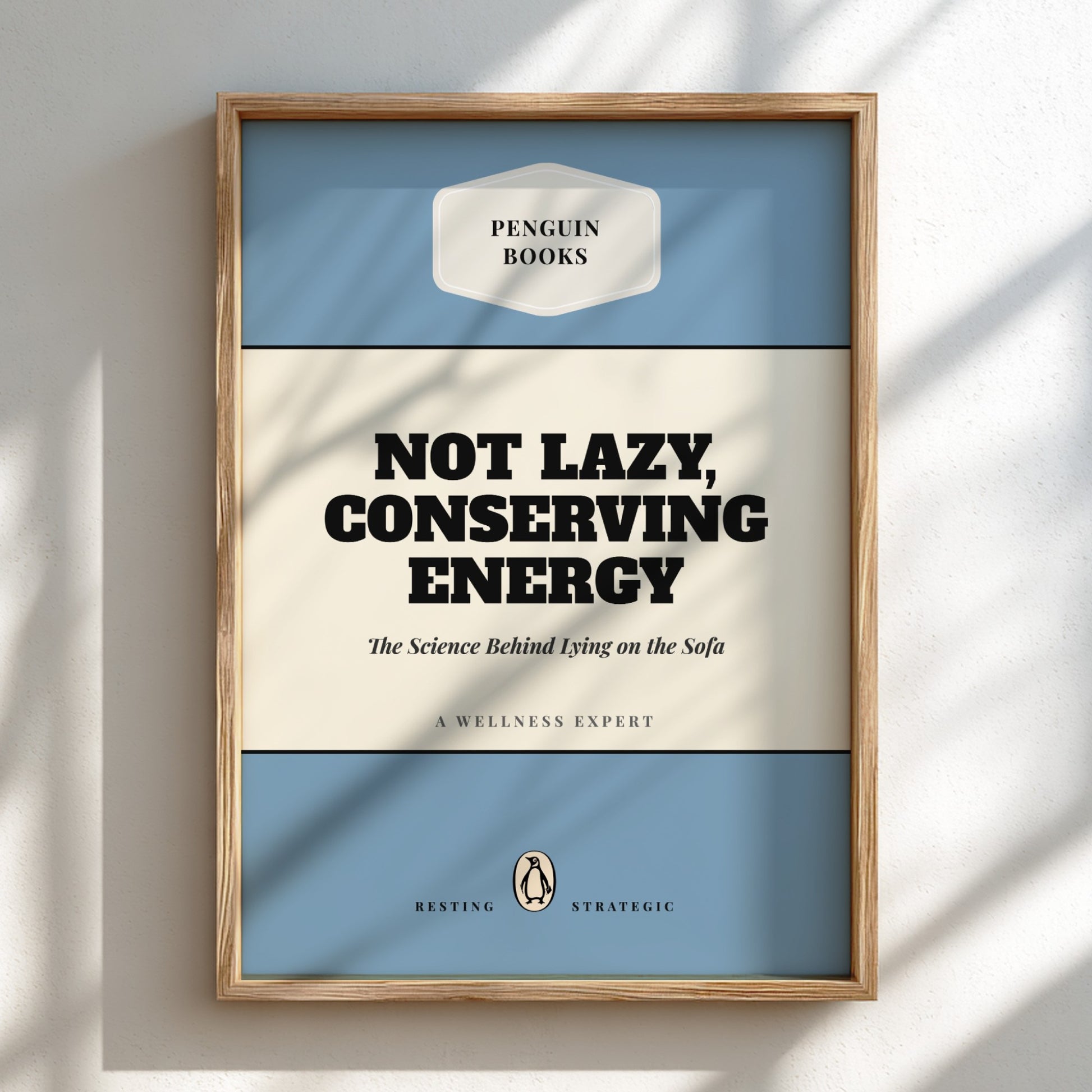 Framed poster with 'Penguin Books' design and text about conserving energy.