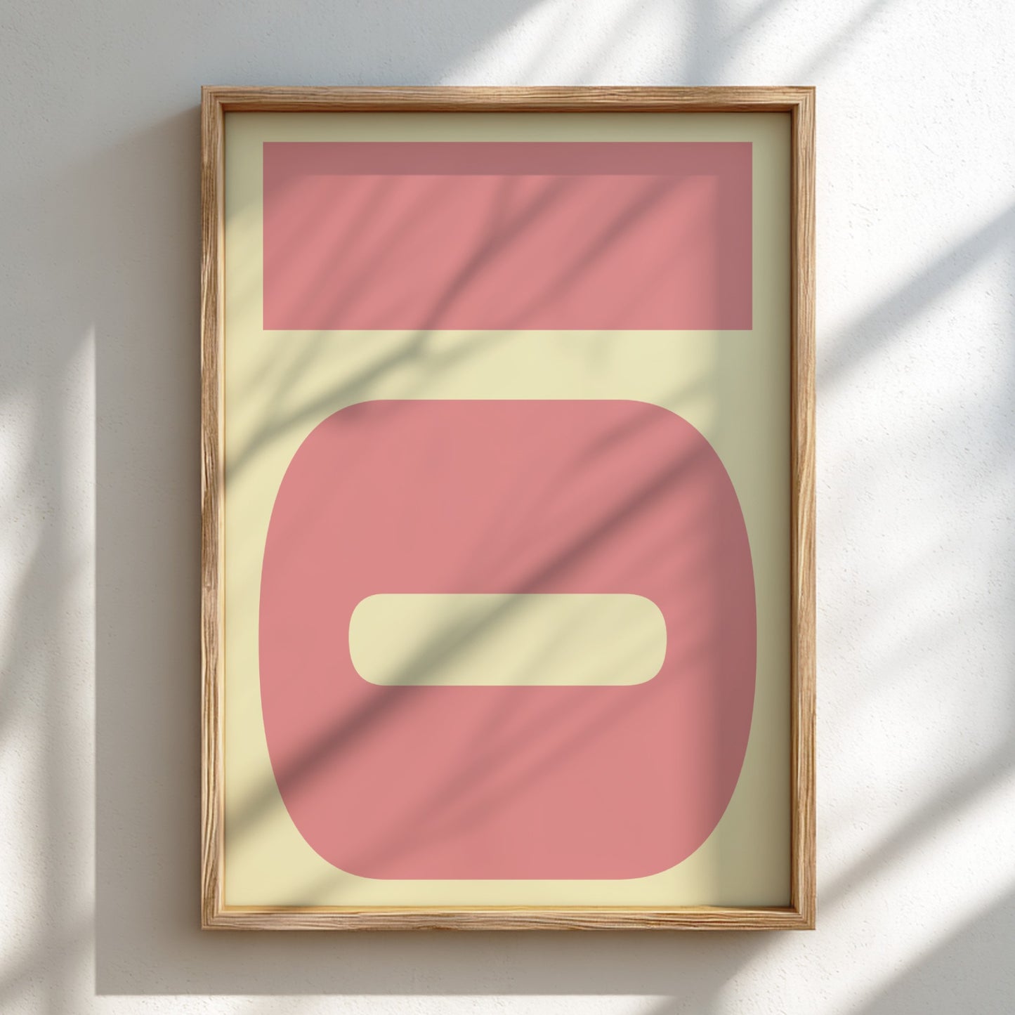 Framed abstract art with pink and beige shapes on a light background