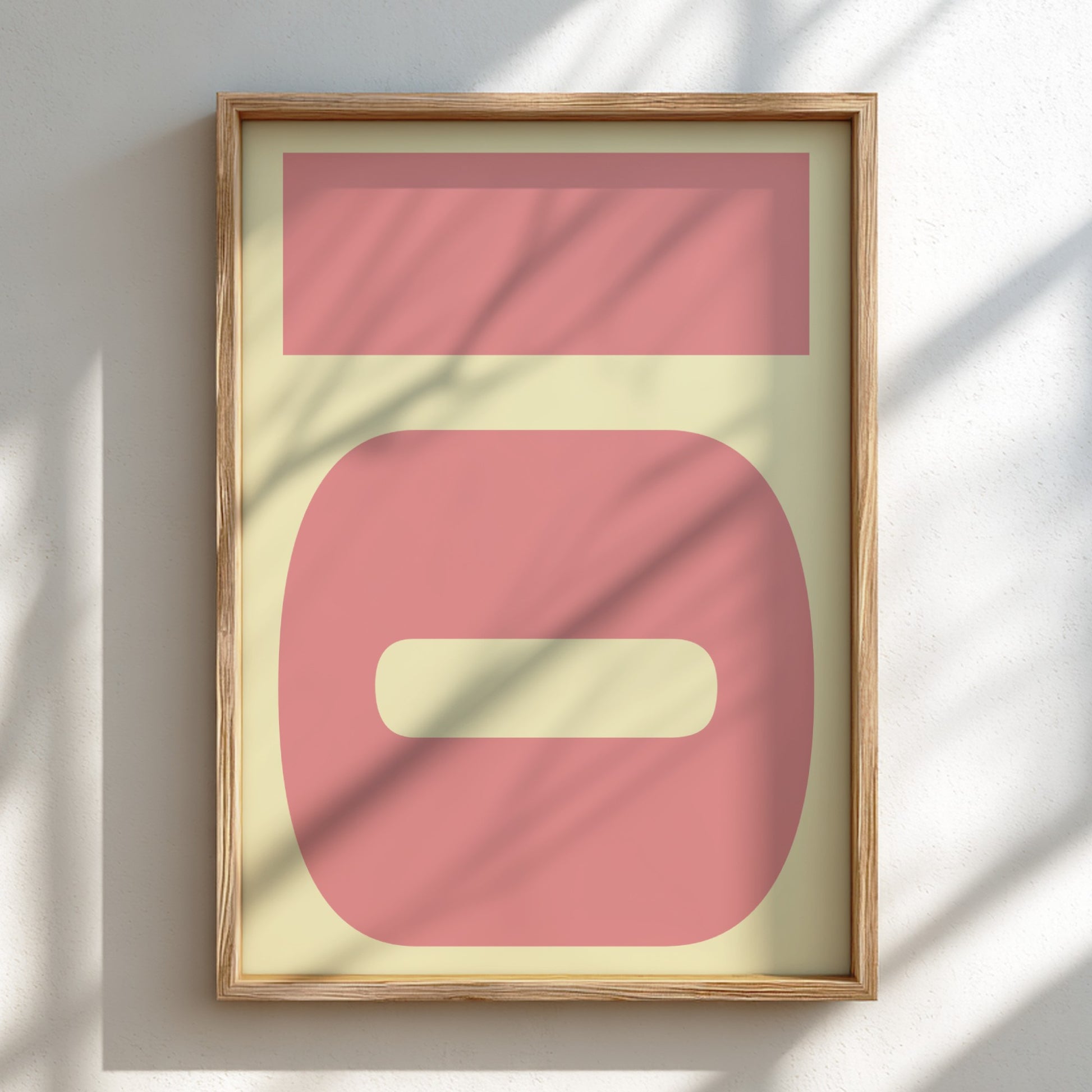 Framed abstract art with pink and beige shapes on a light background