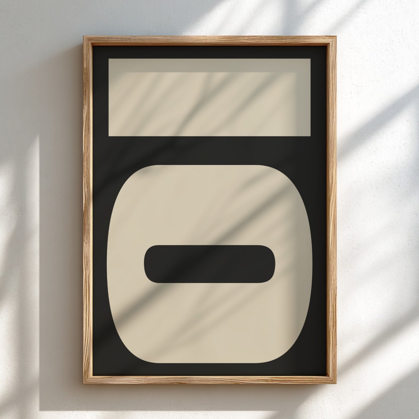 Framed abstract art piece with geometric shapes on a light background