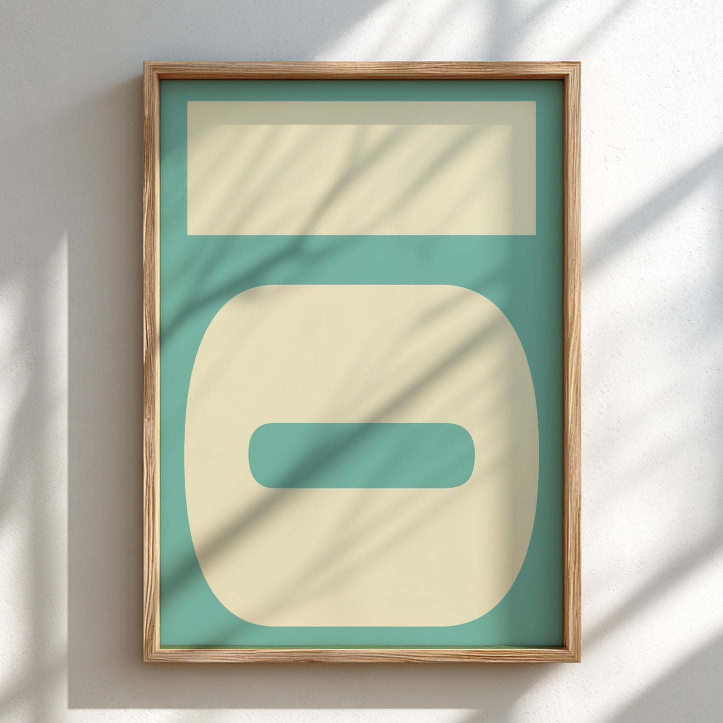 Framed abstract art print with geometric shapes on a teal background