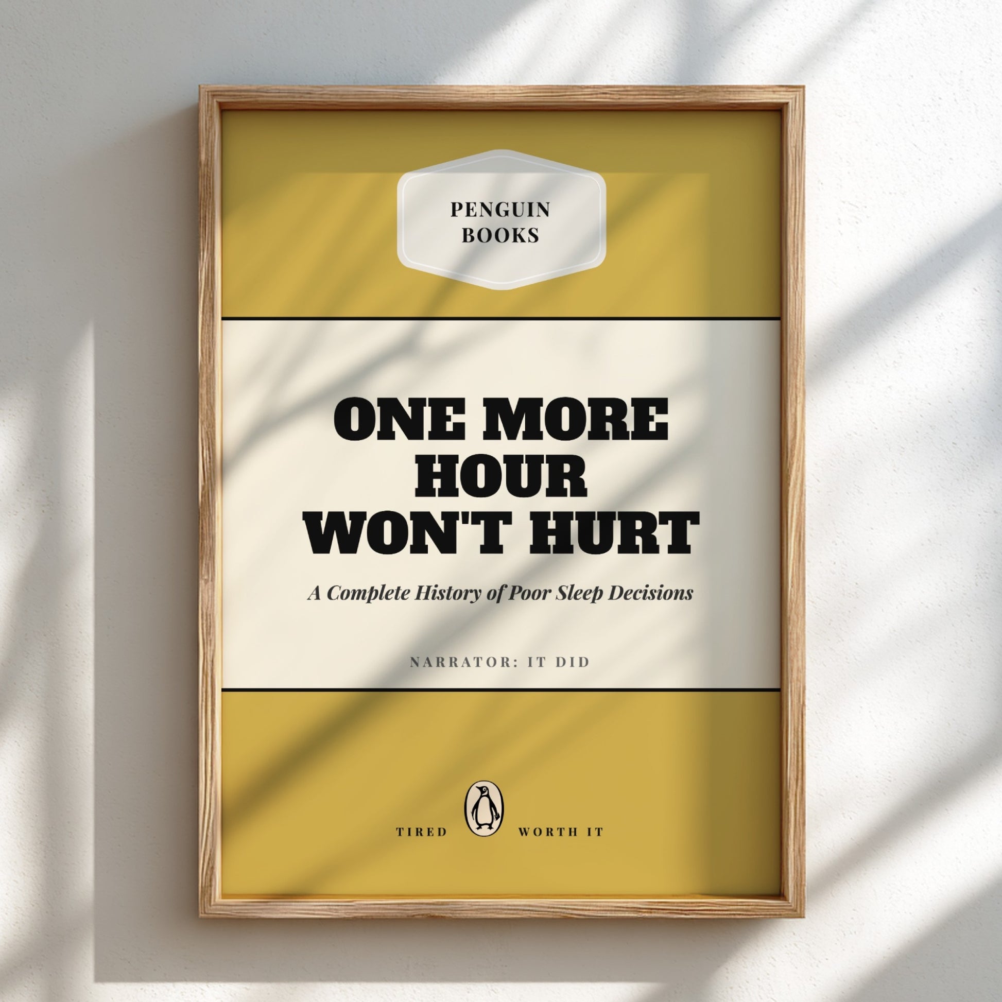 Framed book cover with 'Penguin Books' branding and humorous text on a light background