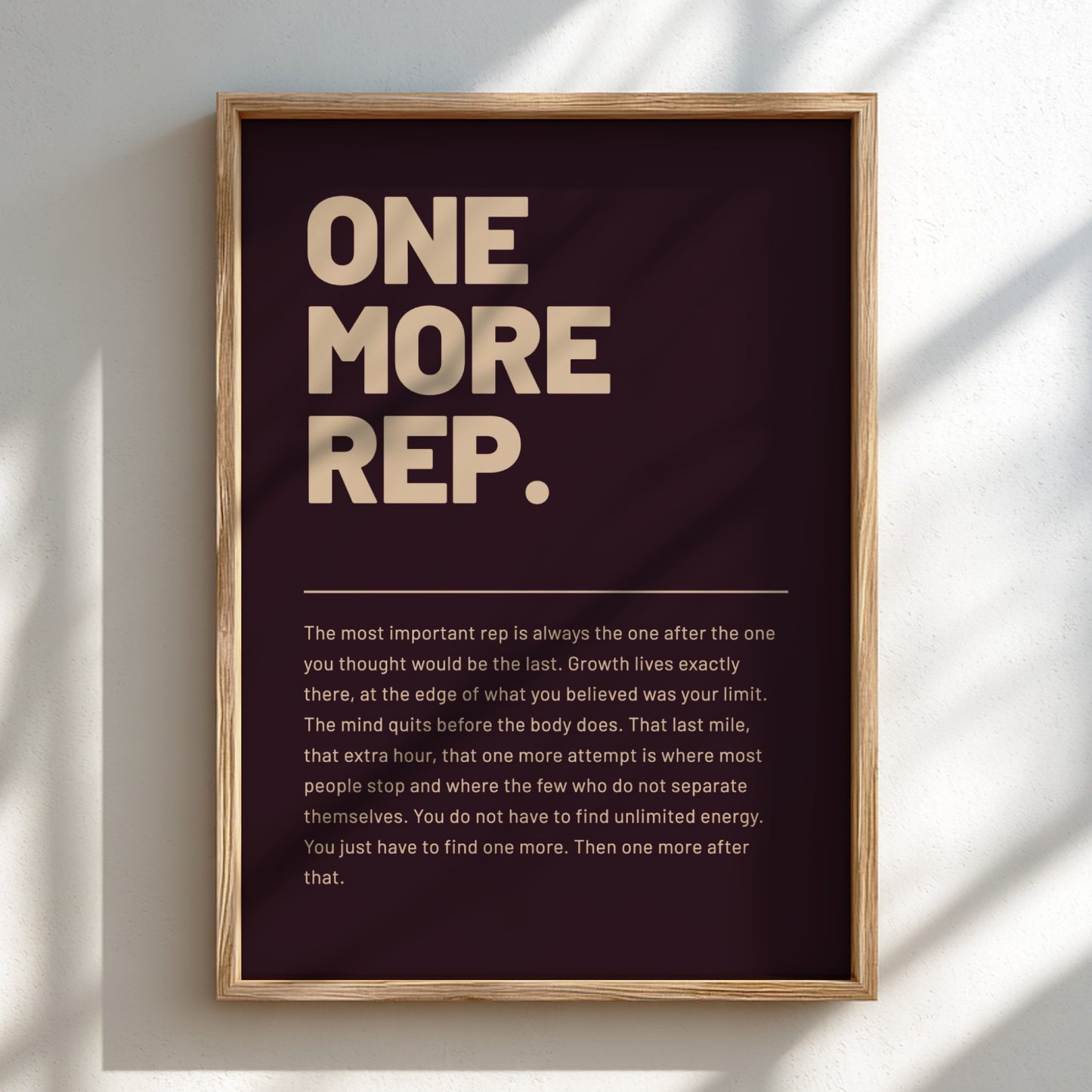 Framed poster with motivational quote 'ONE MORE REP.' on a dark background