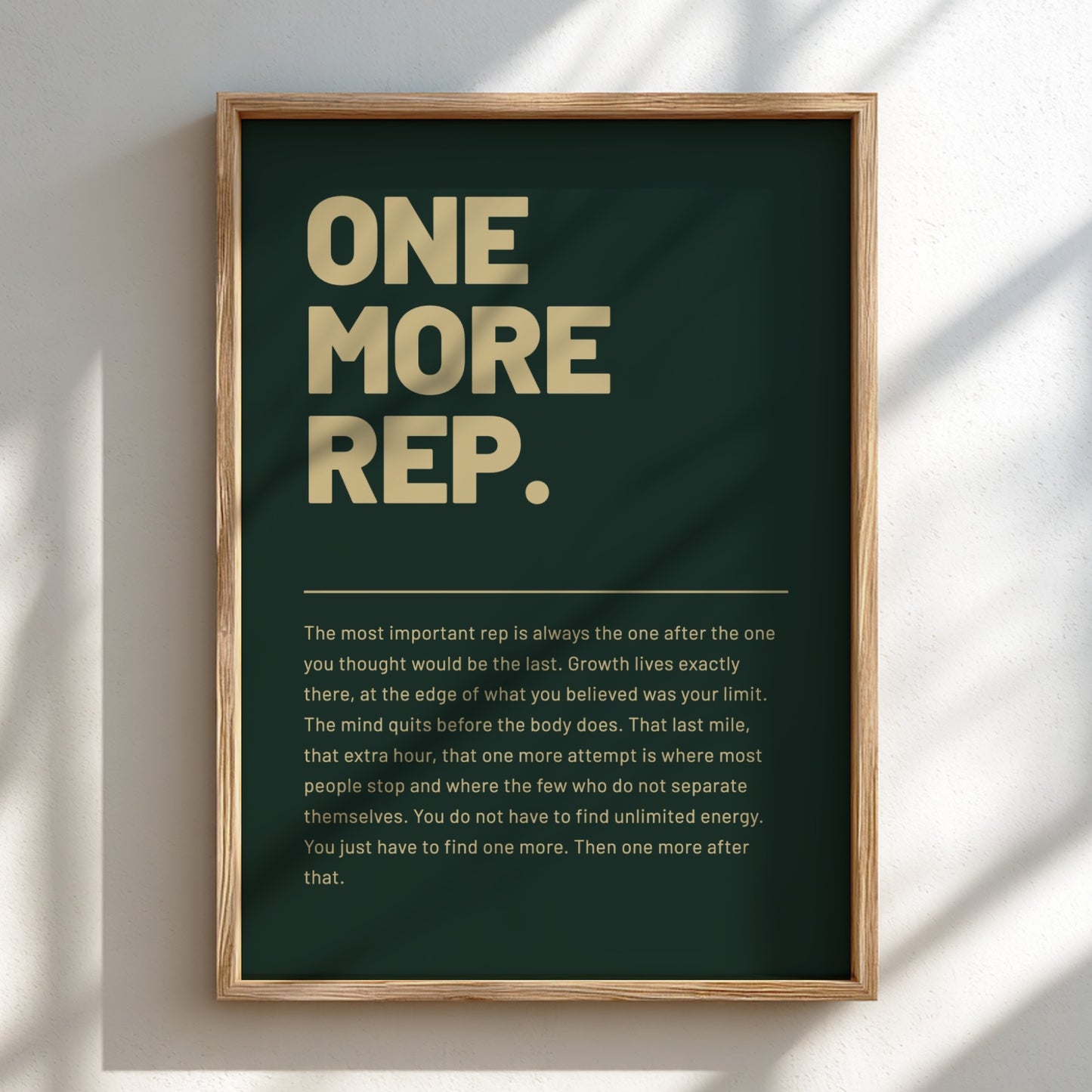Framed poster with motivational quote 'ONE MORE REP.' on a dark green background