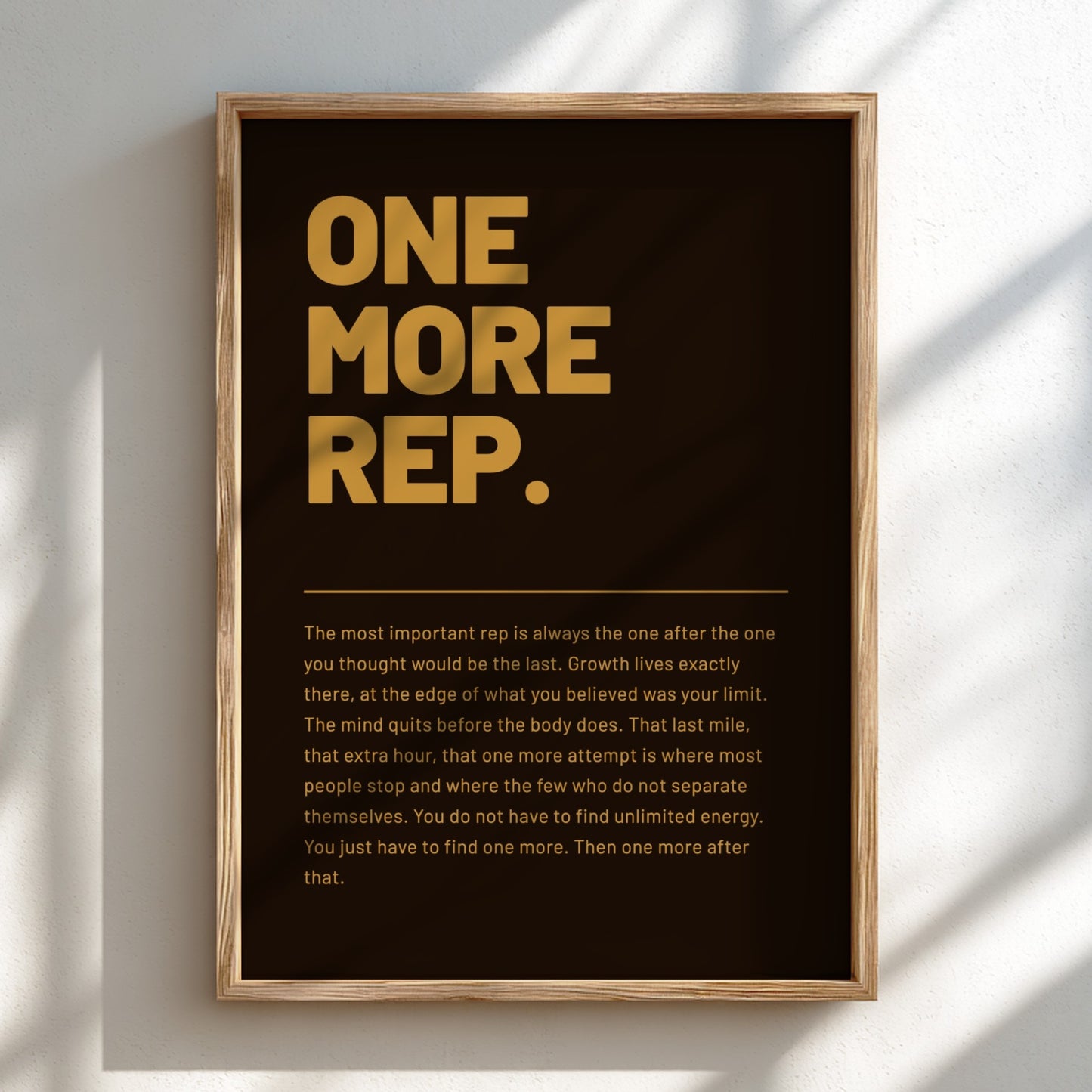 Framed poster with motivational quote 'ONE MORE REP.' on a dark background