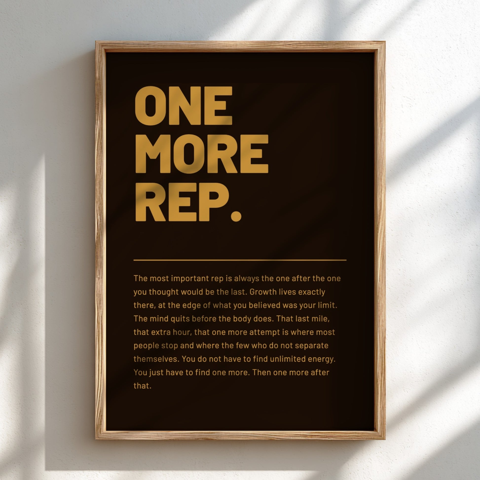 Framed poster with motivational quote 'ONE MORE REP.' on a dark background