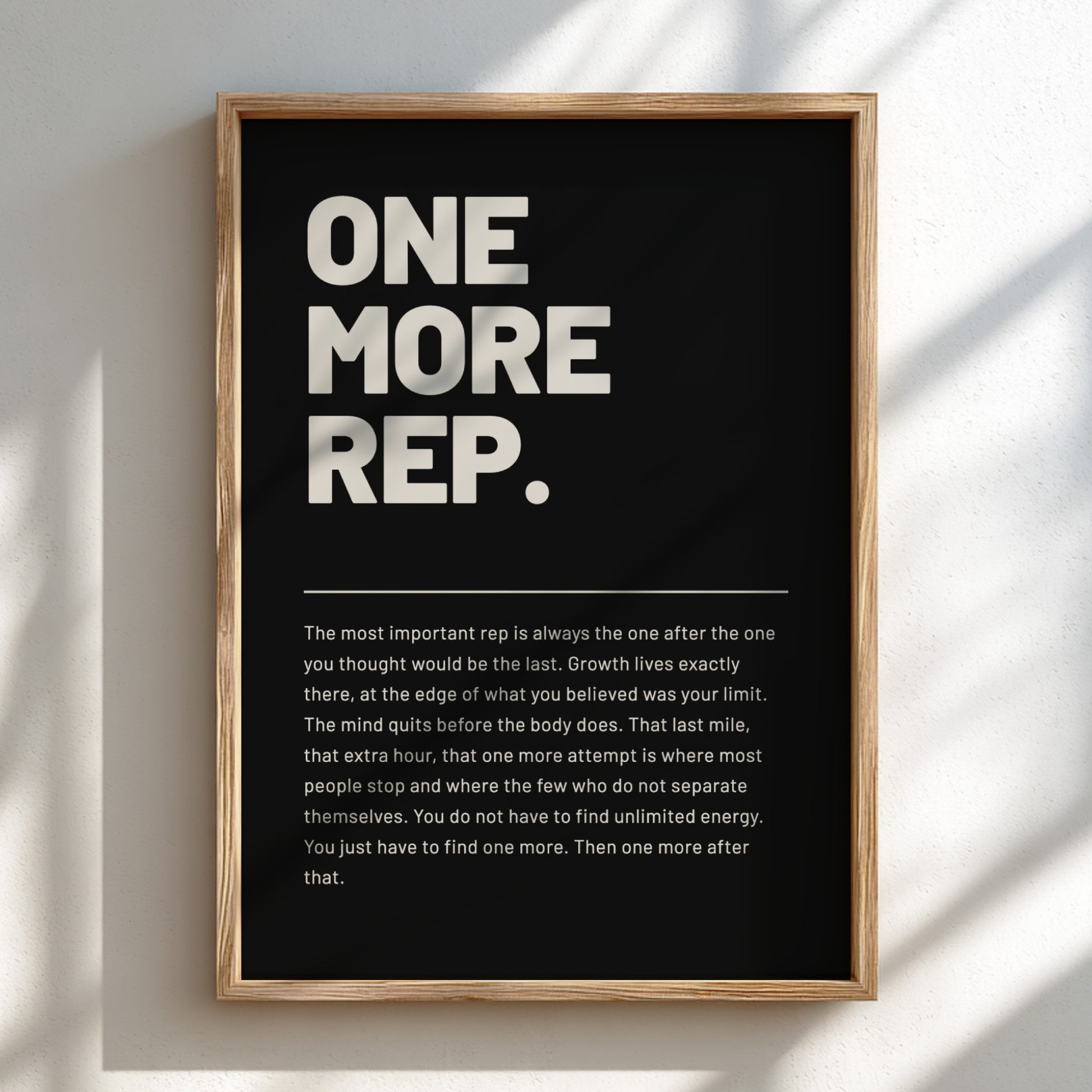 Framed poster with motivational quote 'ONE MORE REP.' on a dark background