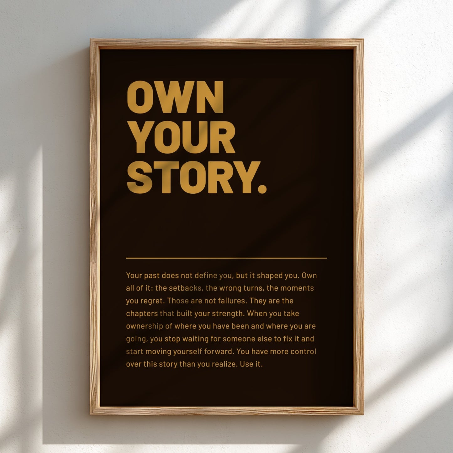 Framed poster with 'Own Your Story' text on a black background