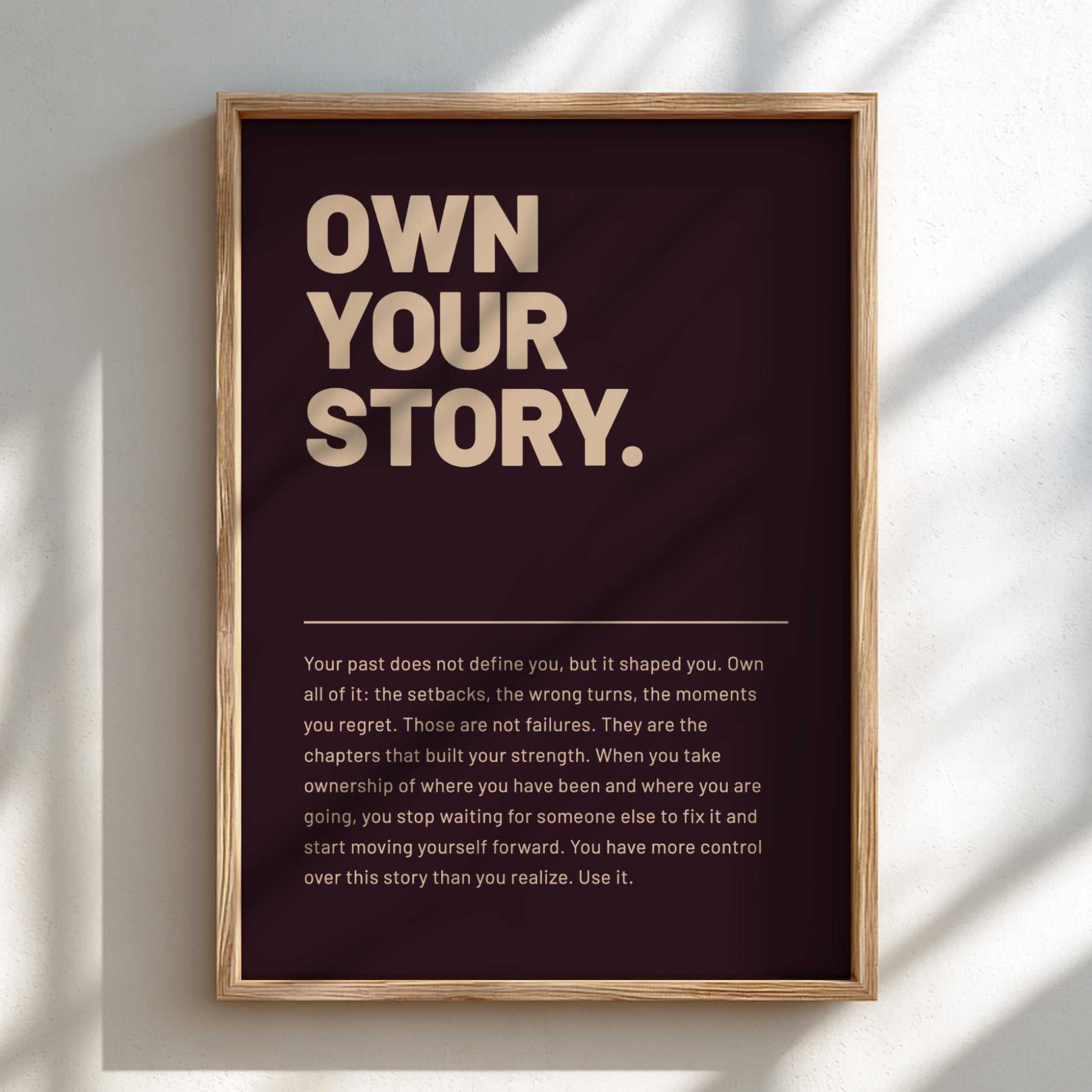 Framed poster with 'Own Your Story' text on a dark background