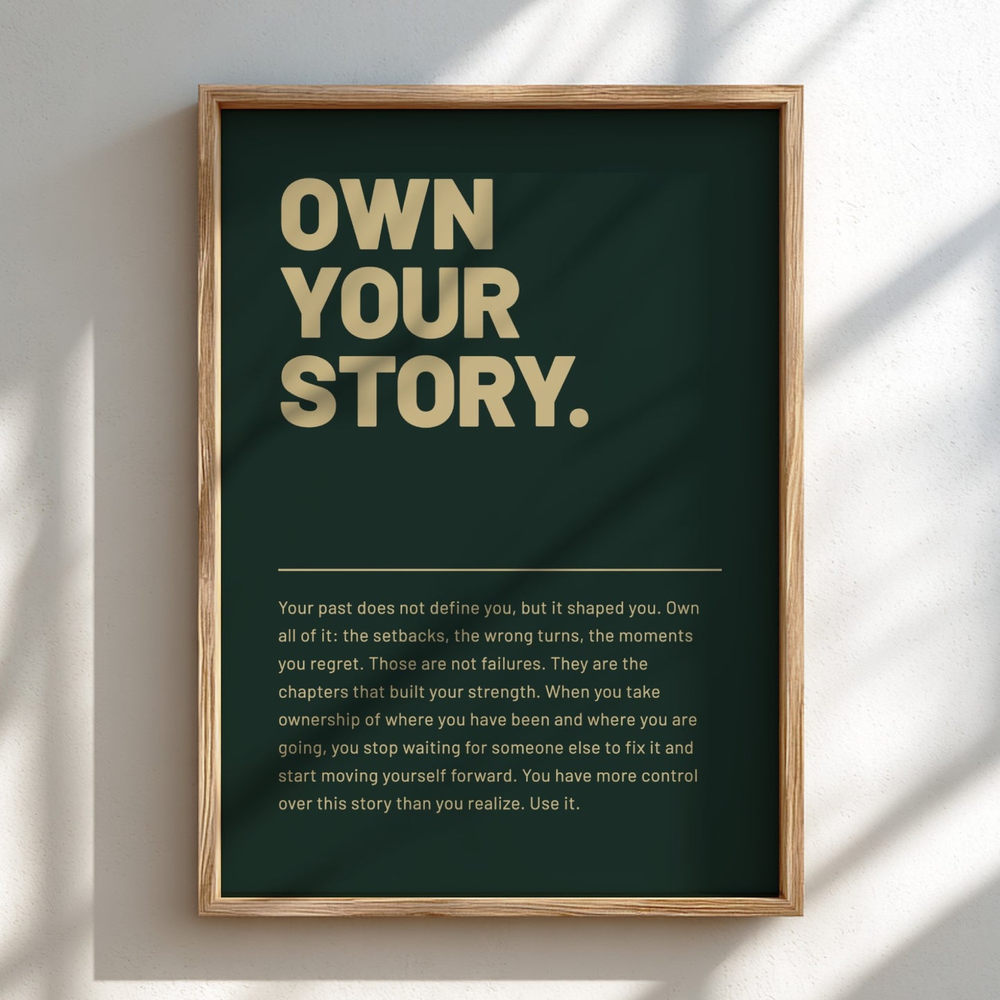 Framed poster with 'Own Your Story' text on a dark green background