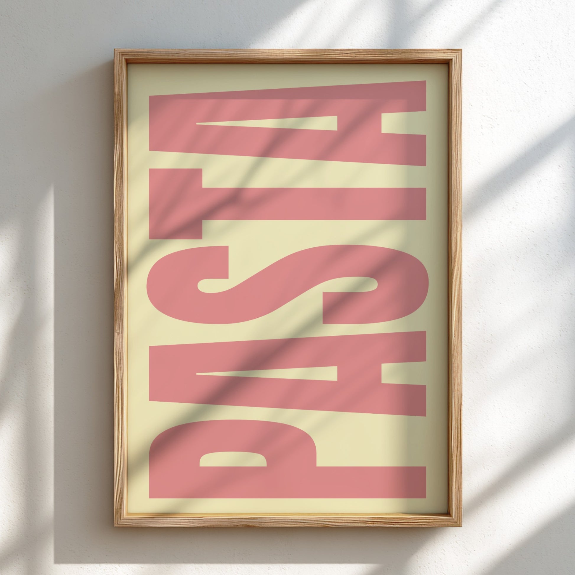 Framed artwork with the word 'PASTA' in pink on a light background