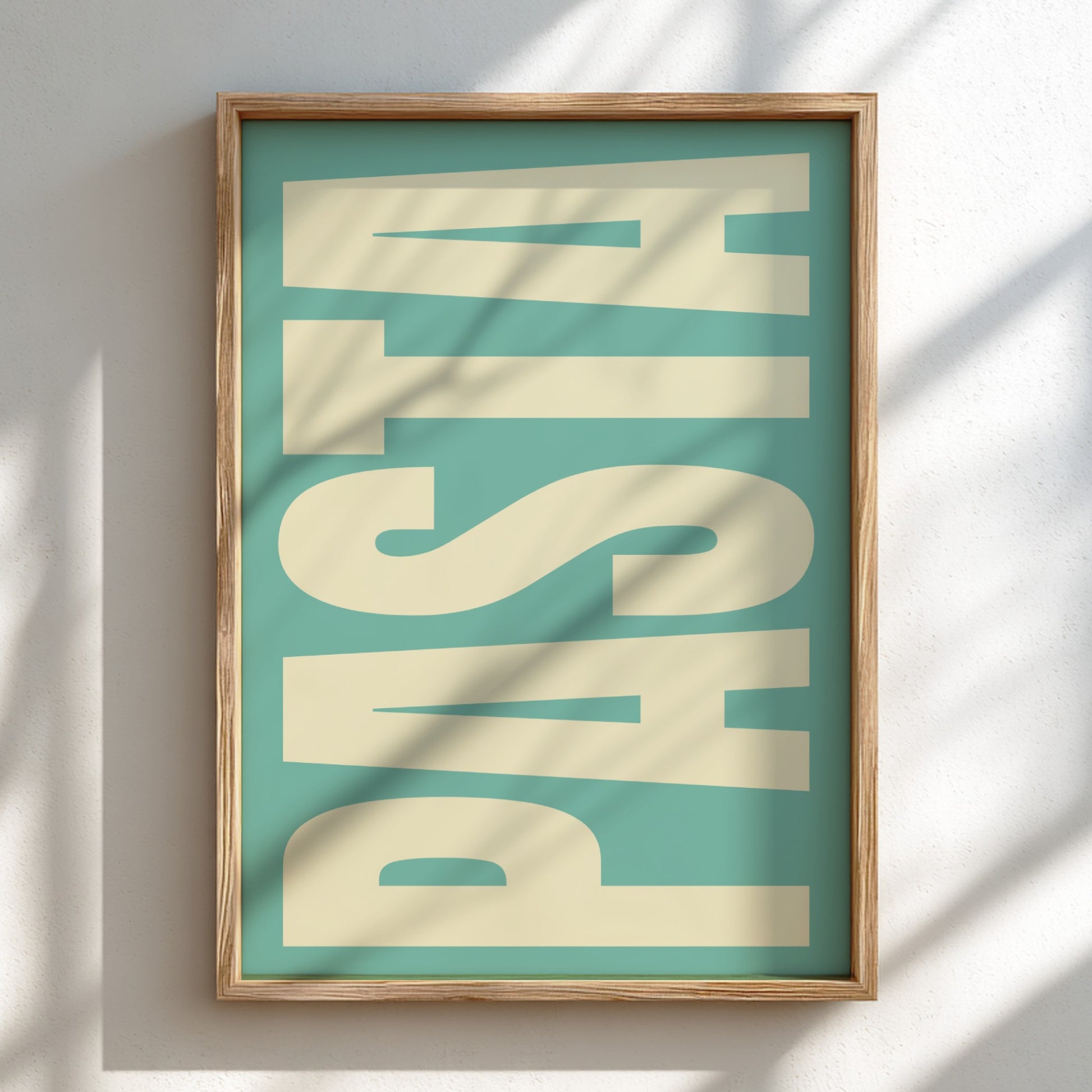 Framed artwork with the word 'PASTA' on a teal background