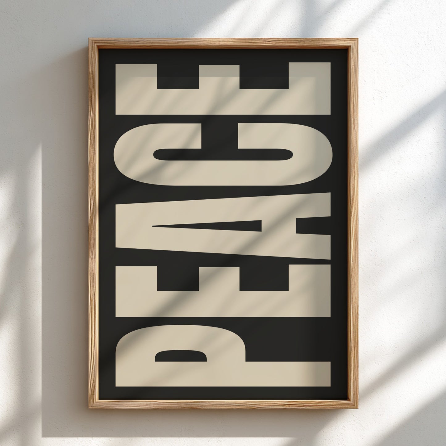 Framed artwork with 'PEACE' text on a black background