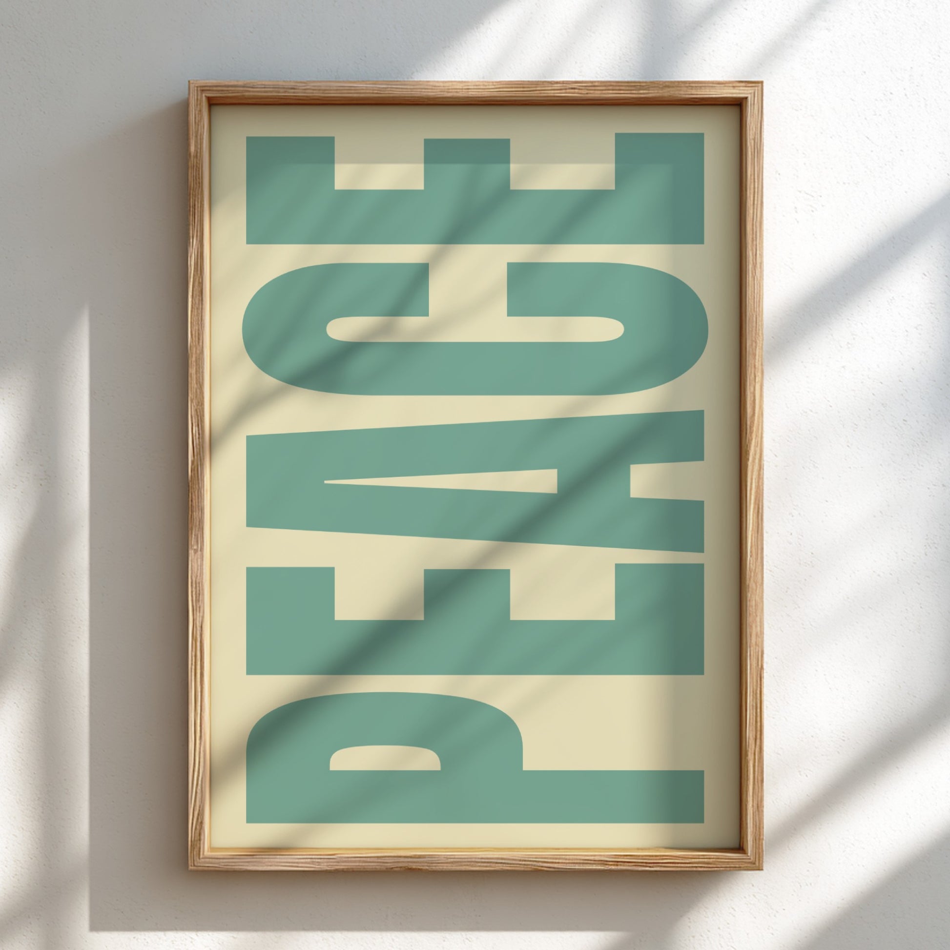 Framed artwork with the word 'PEACE' in green on a beige background