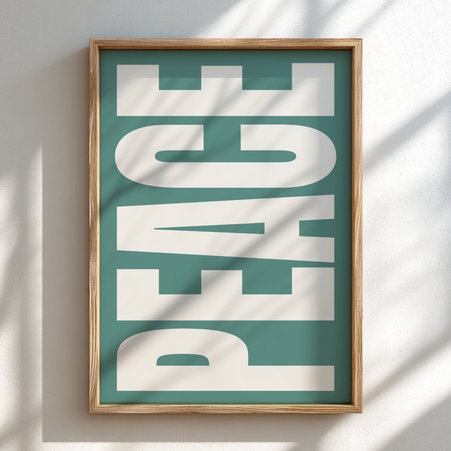 Framed artwork with 'PEACE' text on a teal background