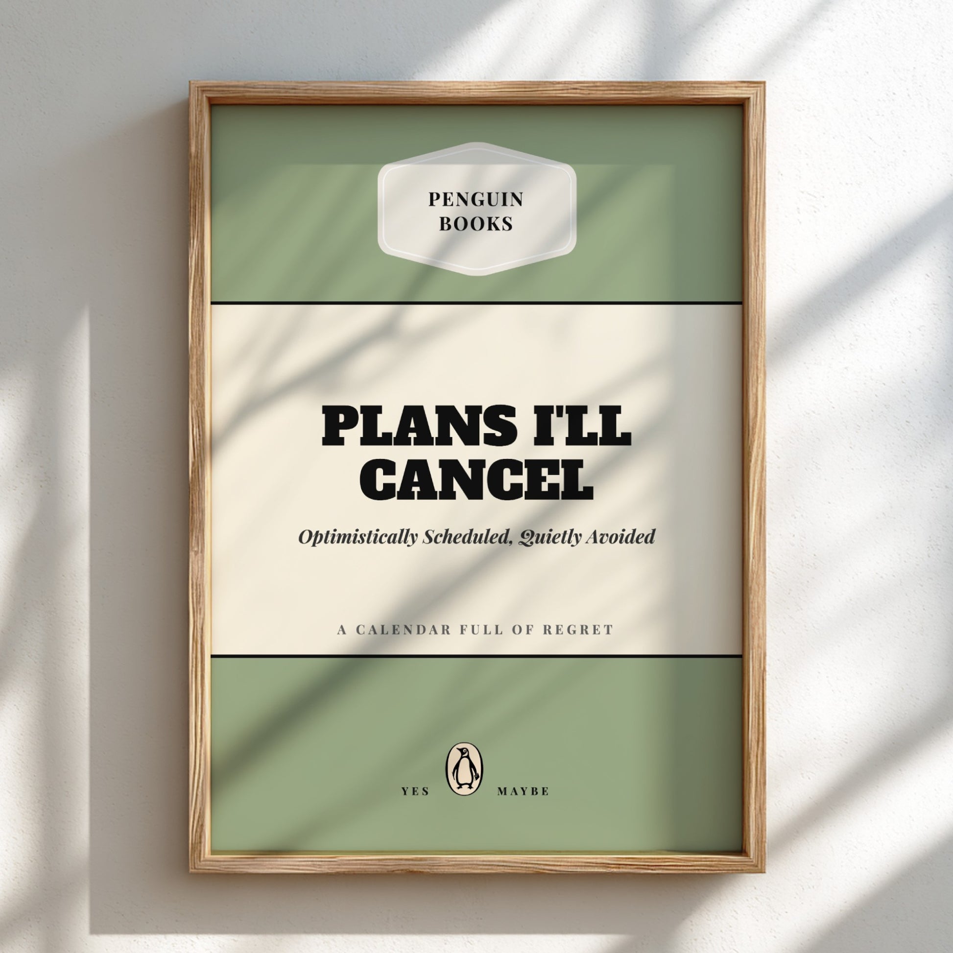 Framed Penguin Books calendar with text 'Plans I'll Cancel' on a light background