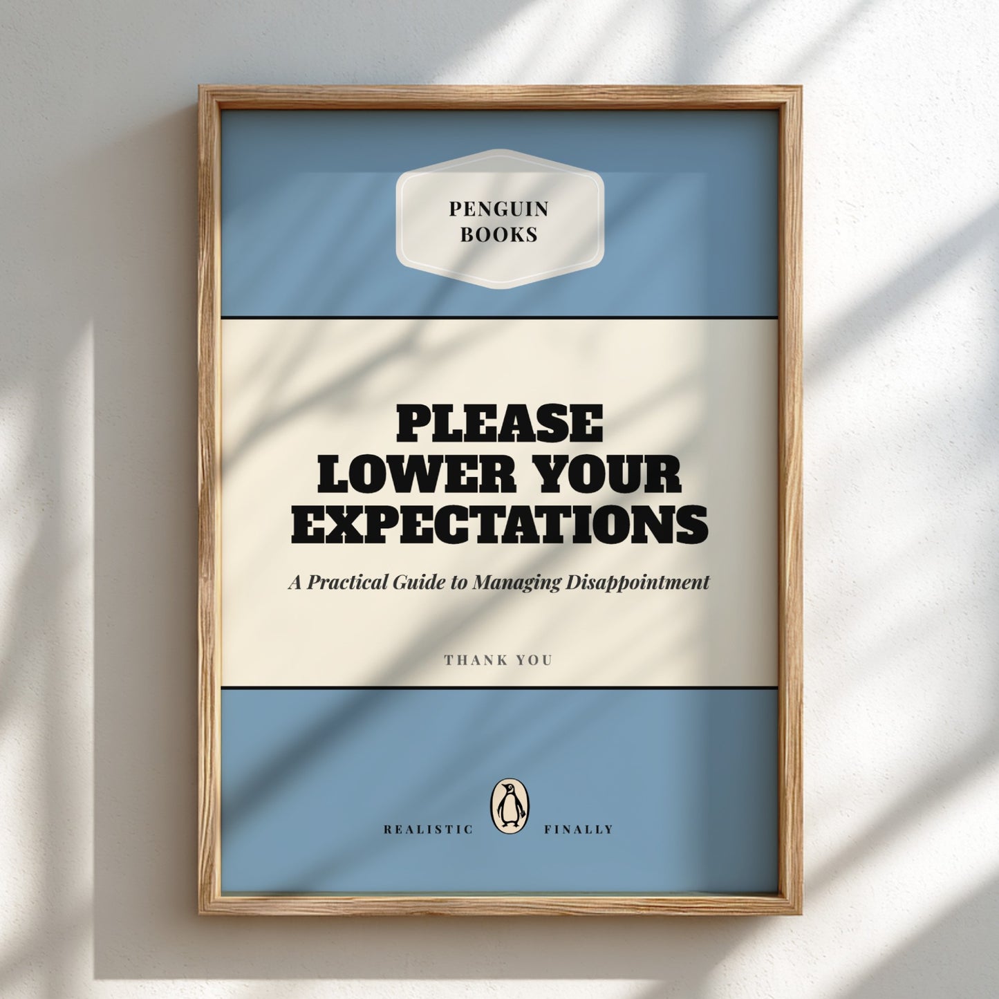 Framed book cover with 'Penguin Books' branding and humorous text on a light background