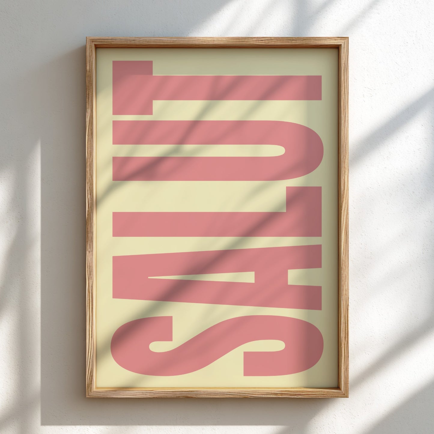 Framed artwork with pink Salut poster featuring modern typography in