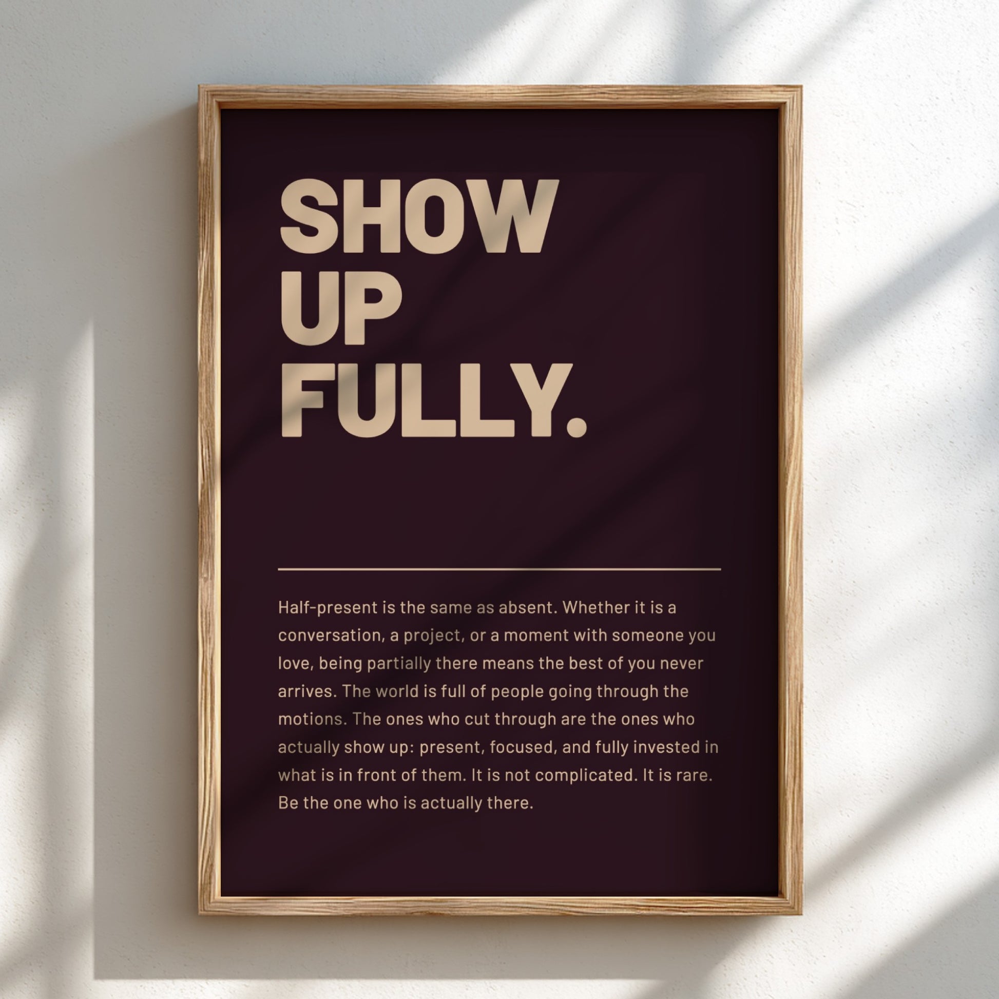 Framed poster with motivational quote 'SHOW UP FULLY.' on a dark background