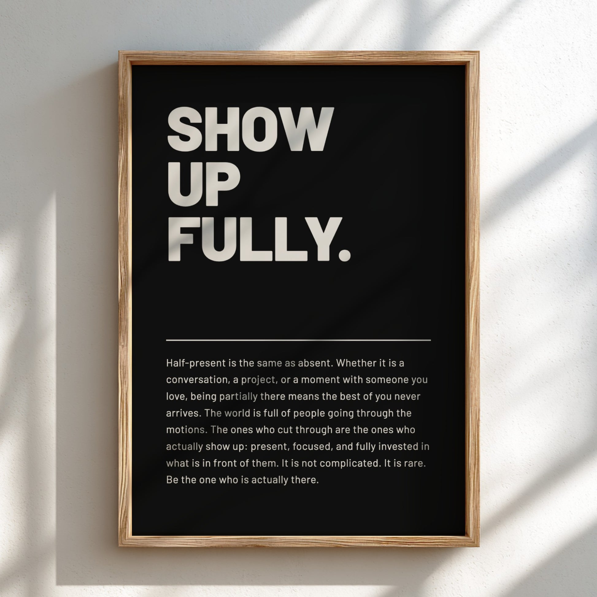 Framed poster with motivational quote 'SHOW UP FULLY.' on a black background