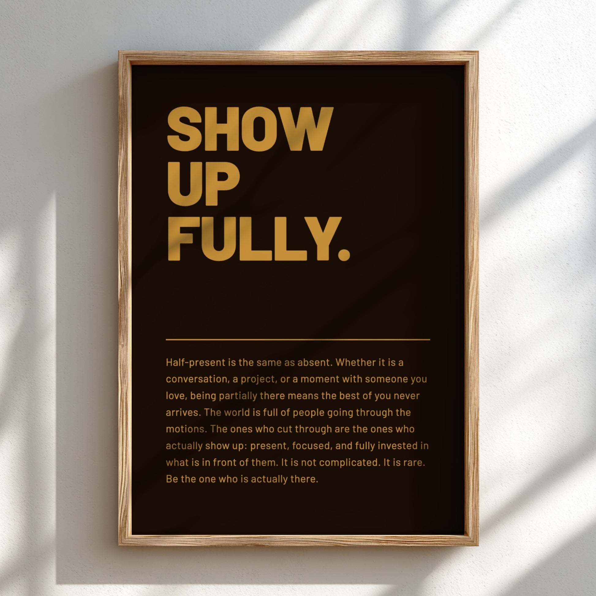 Framed poster with motivational text 'SHOW UP FULLY.' on a dark background