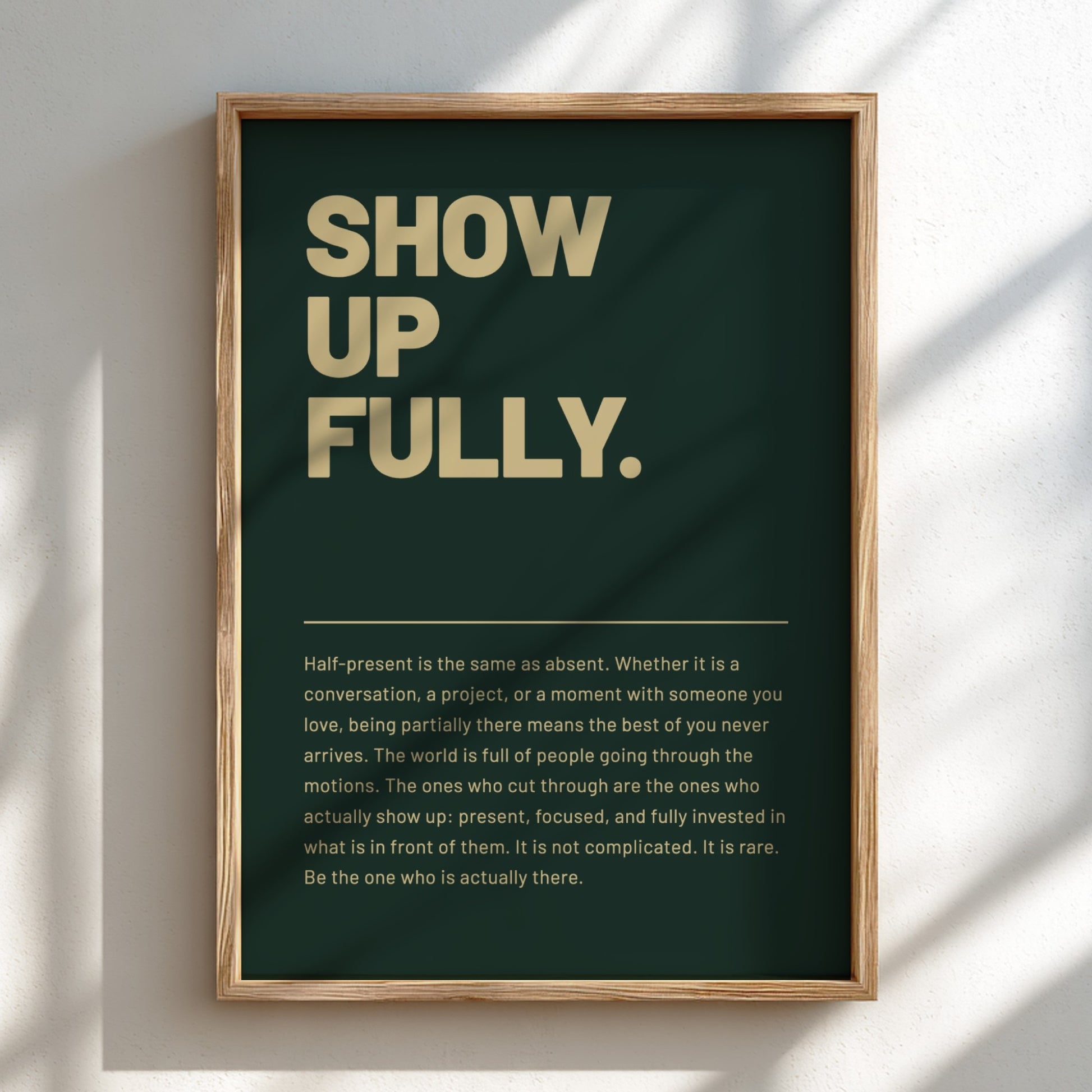Framed poster with motivational text 'SHOW UP FULLY.' on a dark green background.