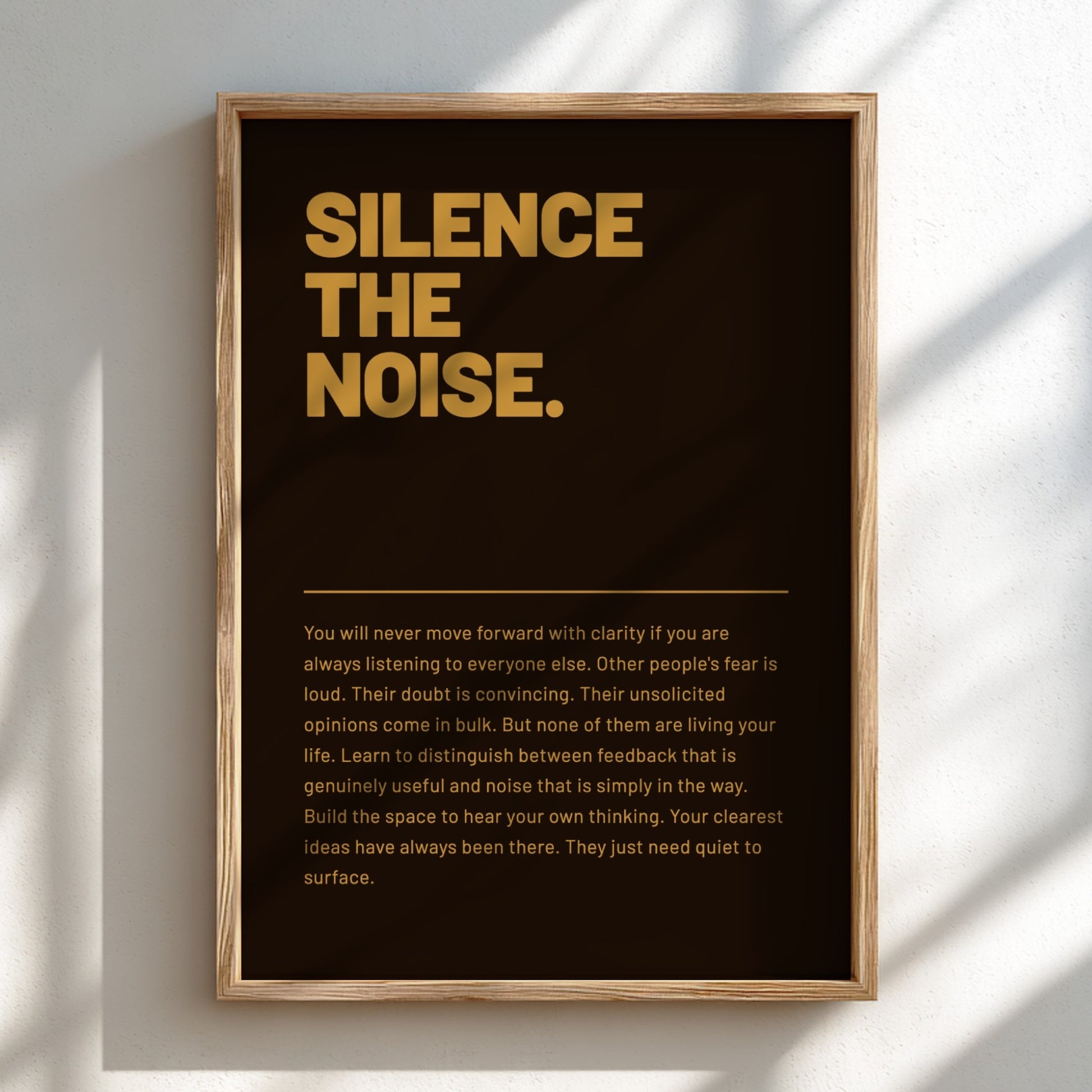 Framed poster with 'Silence the Noise' text on a dark background
