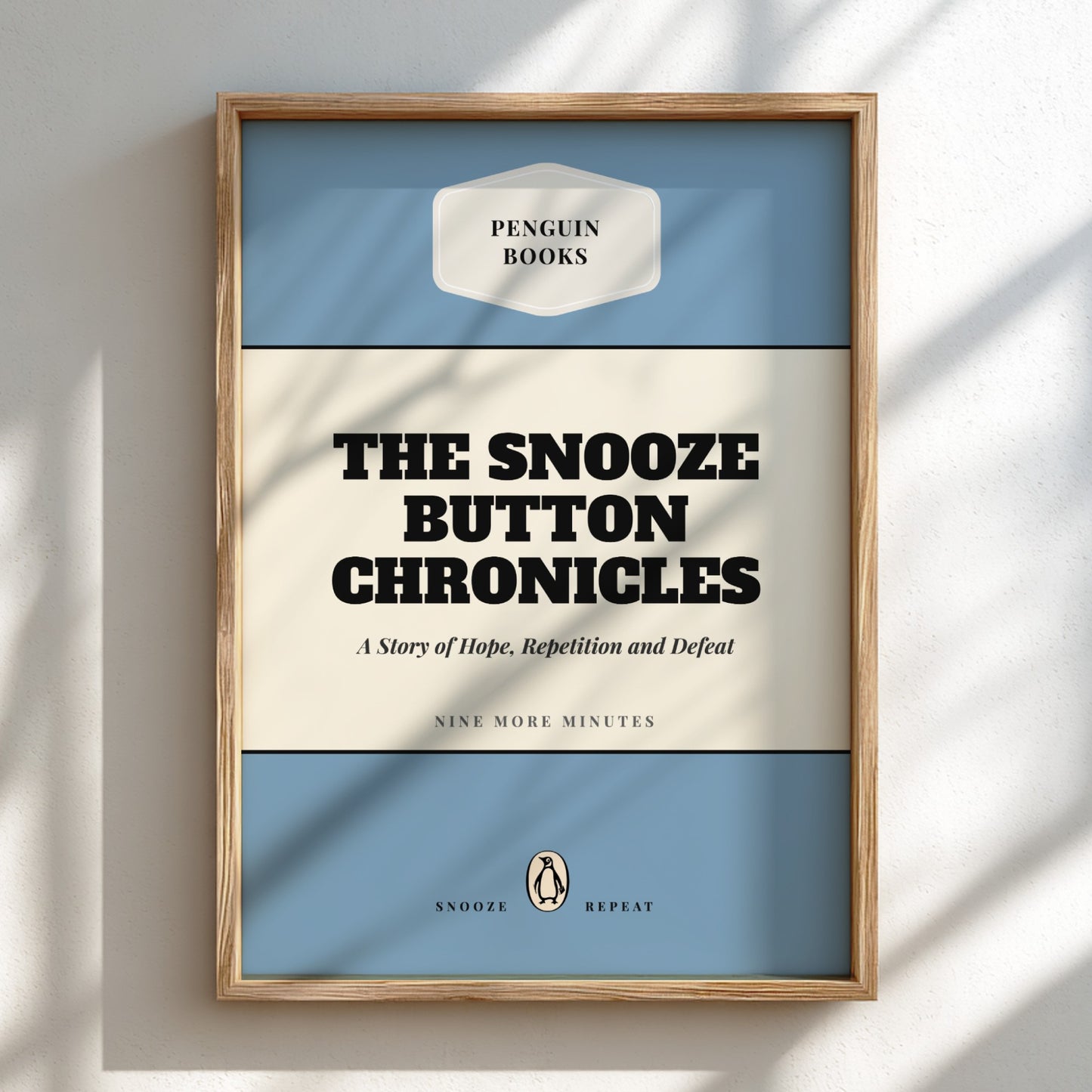 Framed book cover of 'The Snooze Button Chronicles' by Penguin Books on a light background