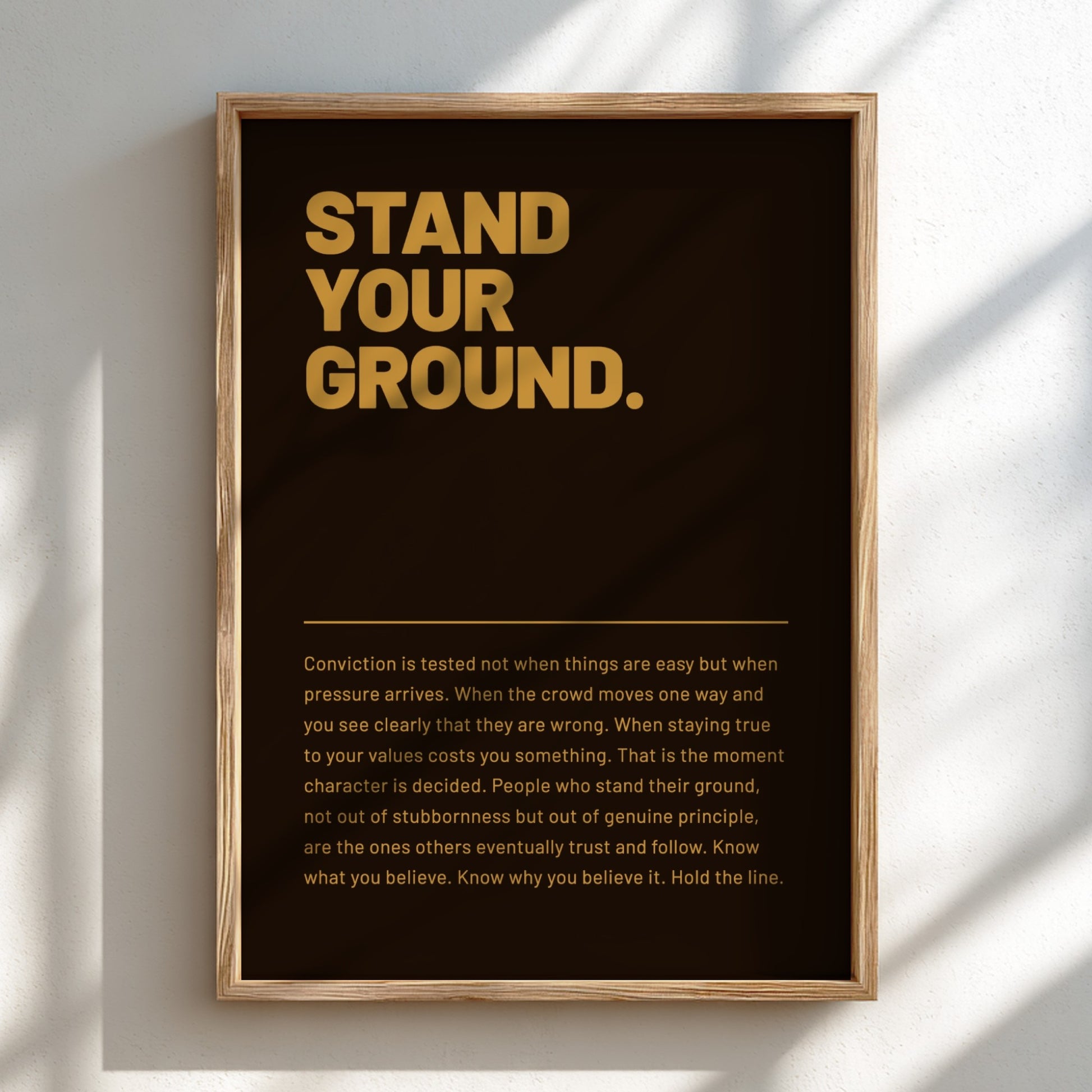 Framed poster with motivational quote 'Stand Your Ground' on a dark background