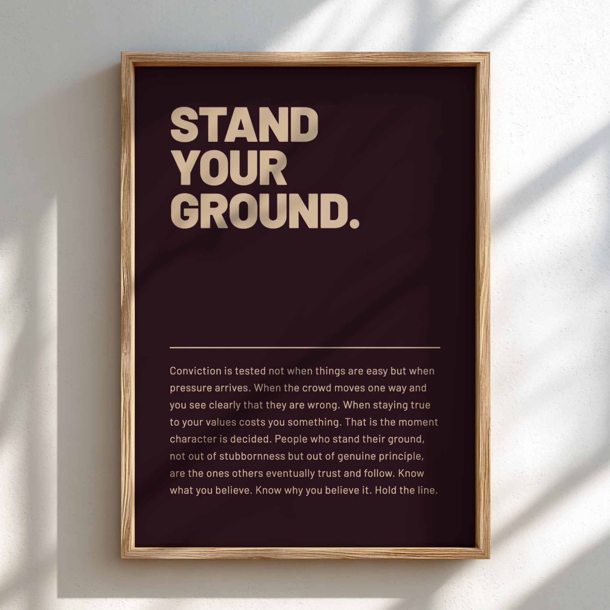 Framed poster with motivational quote 'Stand Your Ground' on a dark background