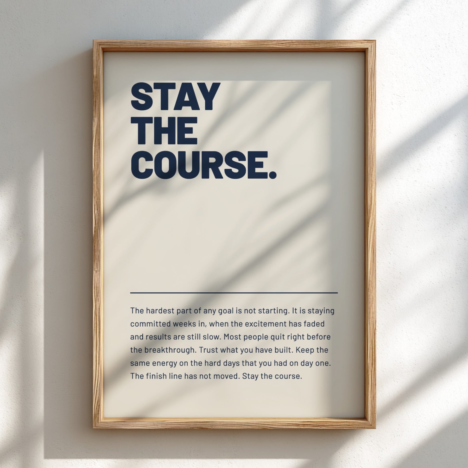 Framed motivational poster with text 'Stay the Course' on a light background