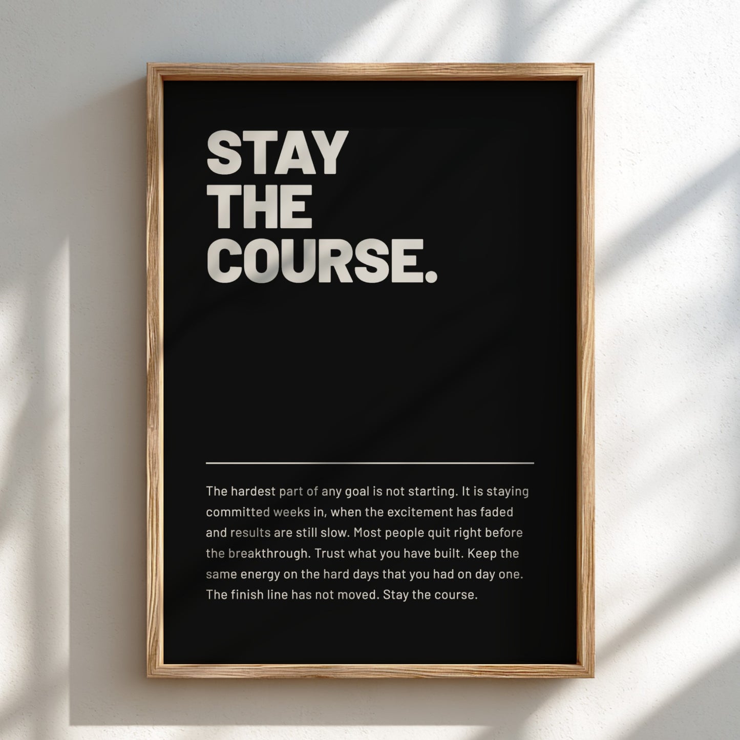 Framed poster with 'Stay the Course.' text on a black background