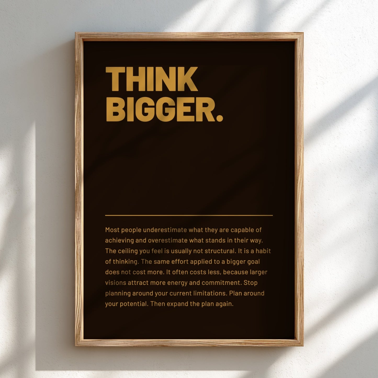Framed poster with 'Think Bigger' text on a dark background