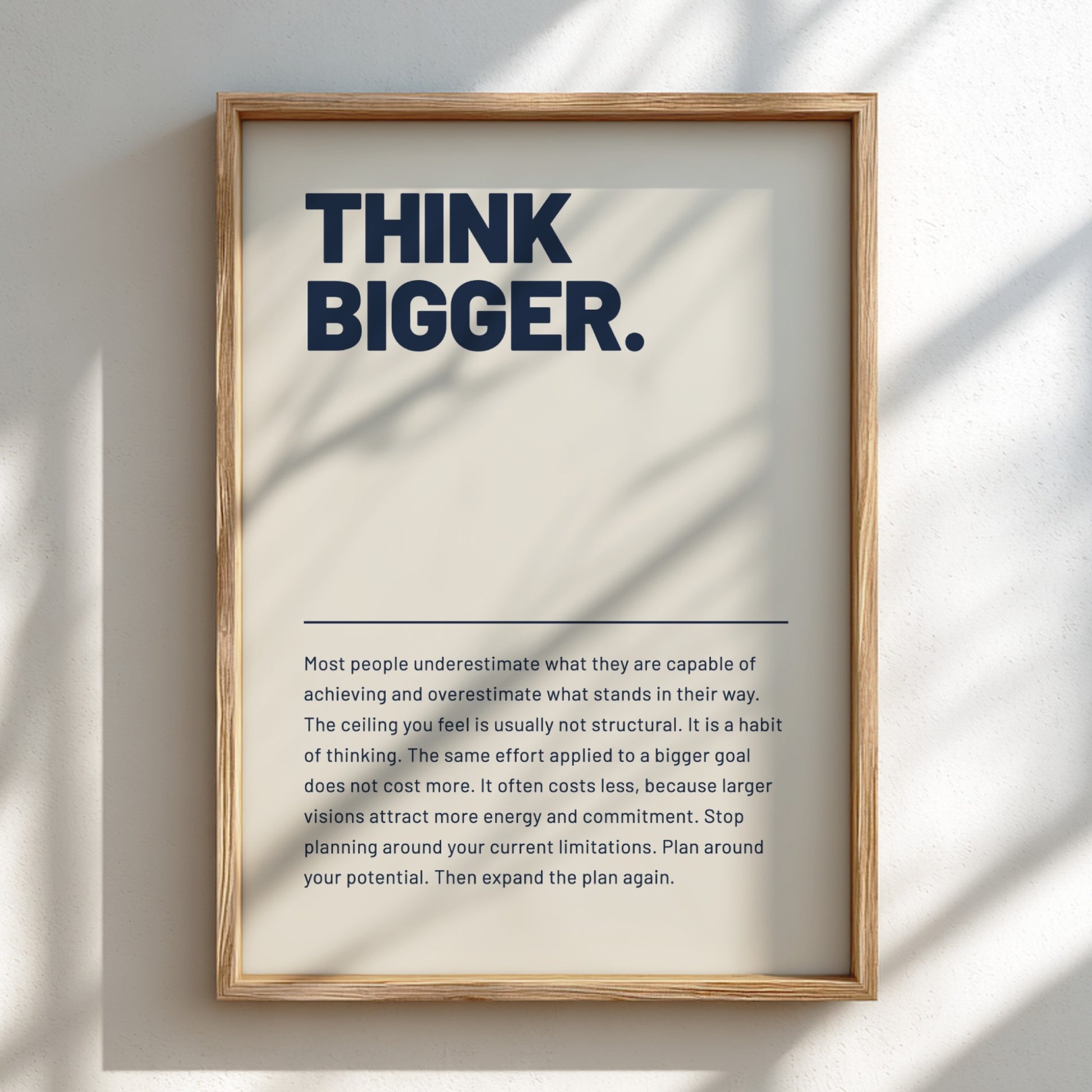 Framed poster with 'Think Bigger' text on a light background