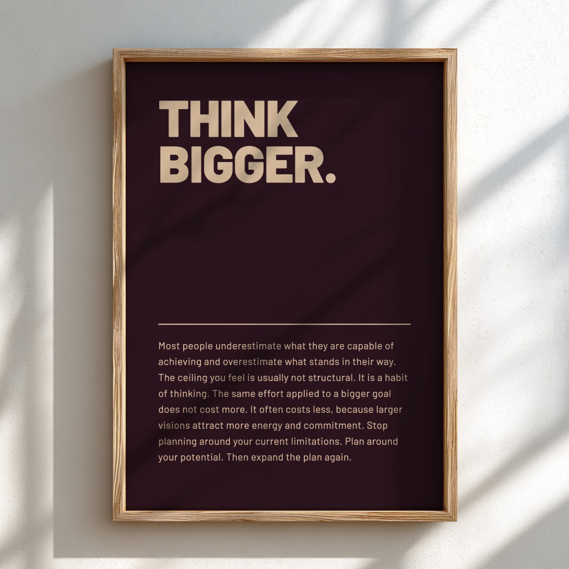Framed poster with 'Think Bigger' text on a dark background
