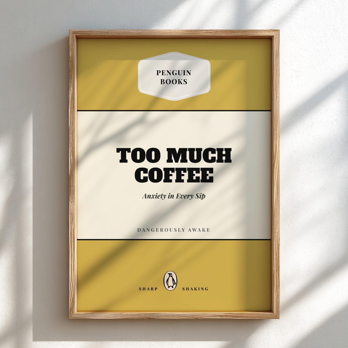 Framed book cover with 'Penguin Books' branding and text 'Too Much Coffee'.