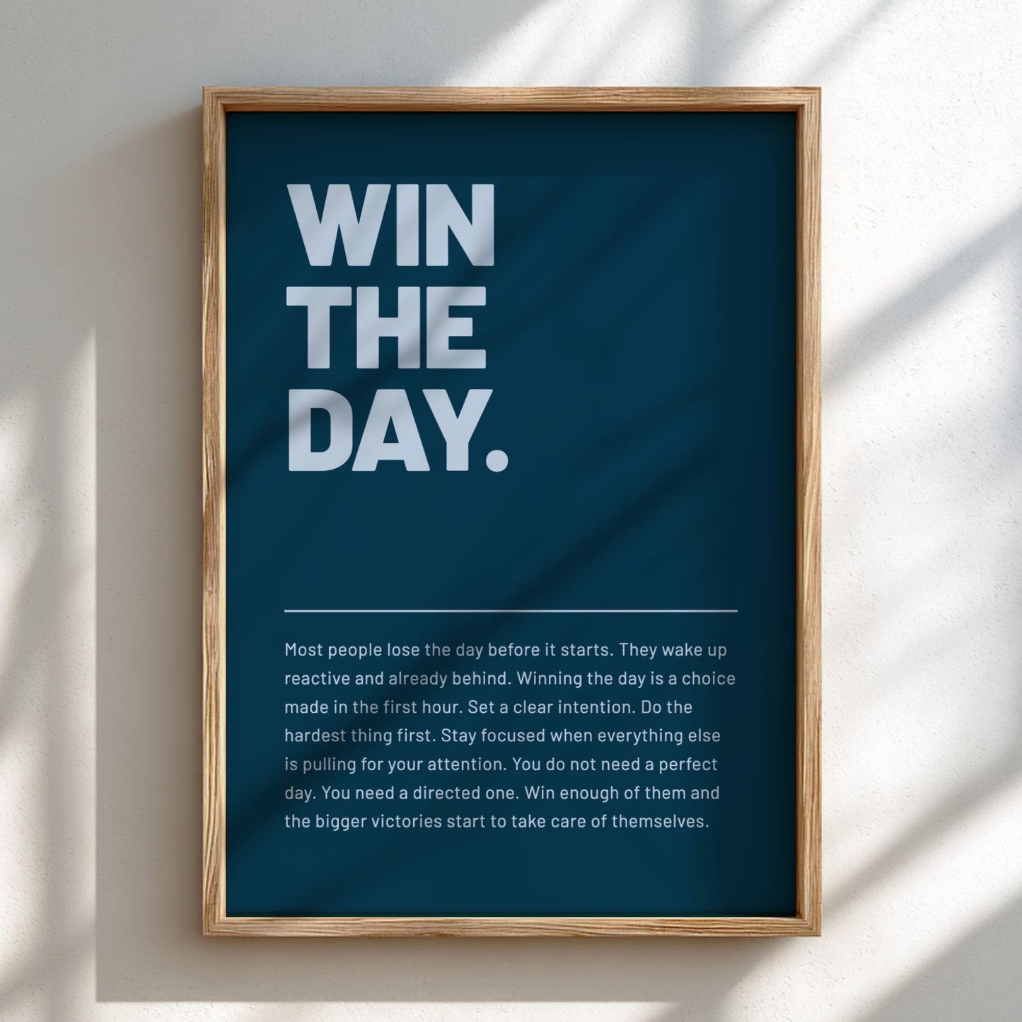 Framed motivational poster with 'WIN THE DAY.' text on a blue background