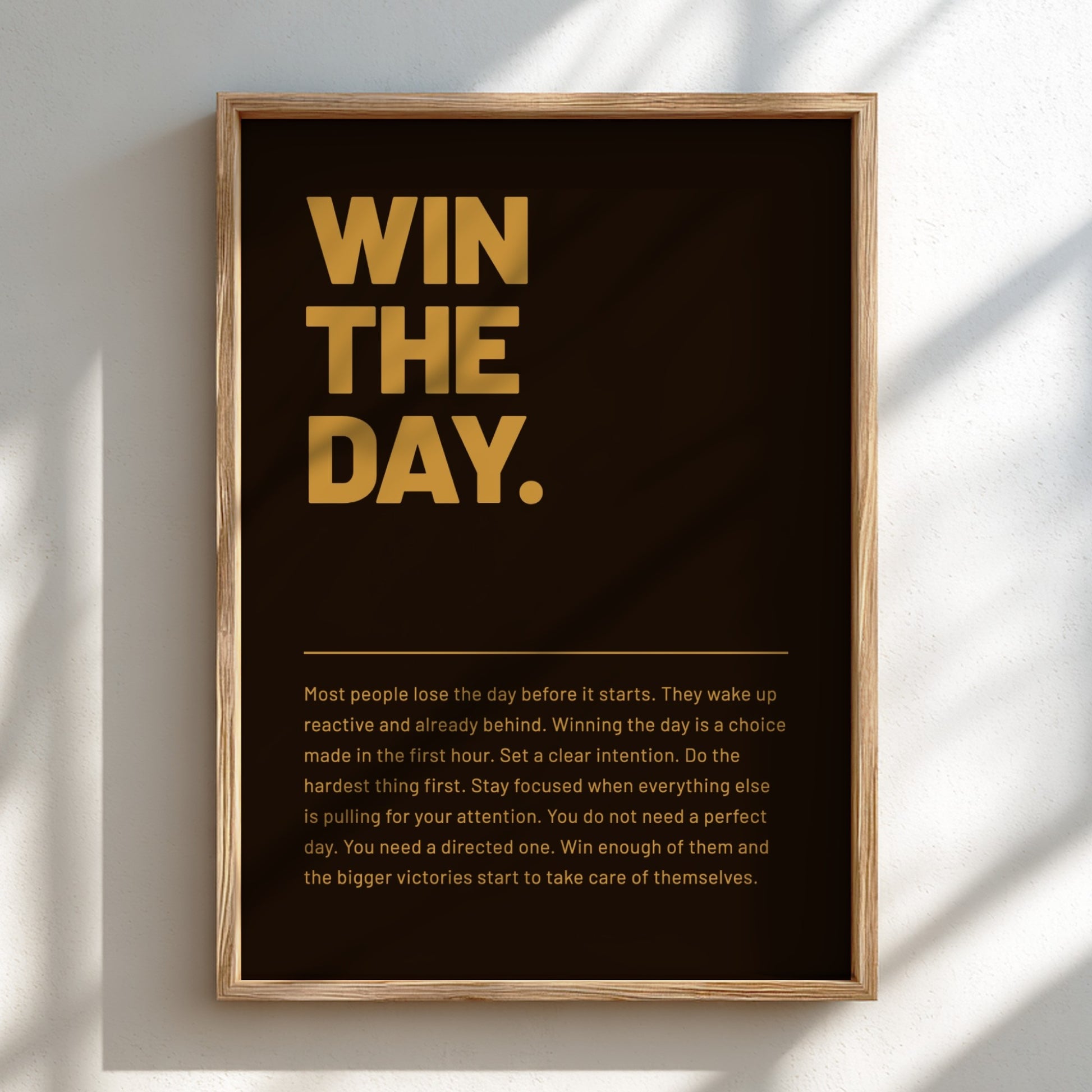 Framed poster with motivational text 'WIN THE DAY.' on a dark background
