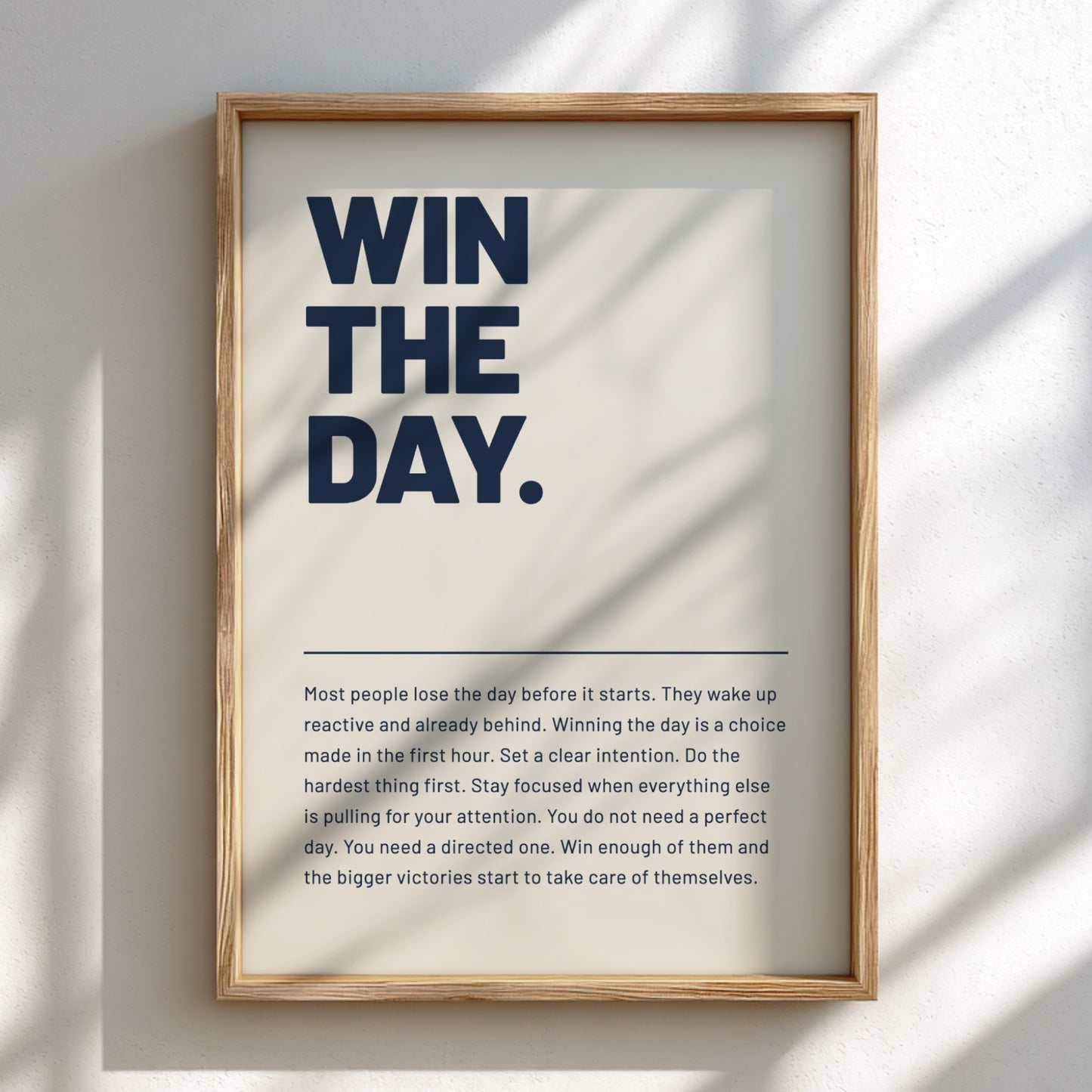 Framed motivational poster with 'WIN THE DAY.' text on a light background