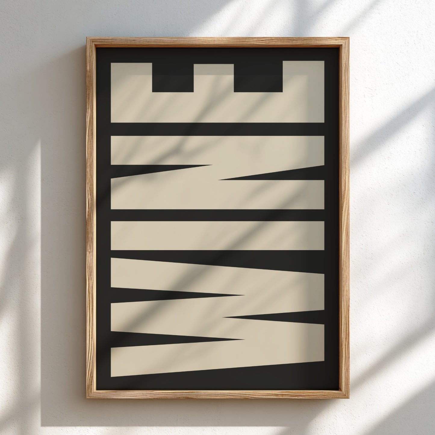 Framed abstract art piece with geometric shapes on a white wall