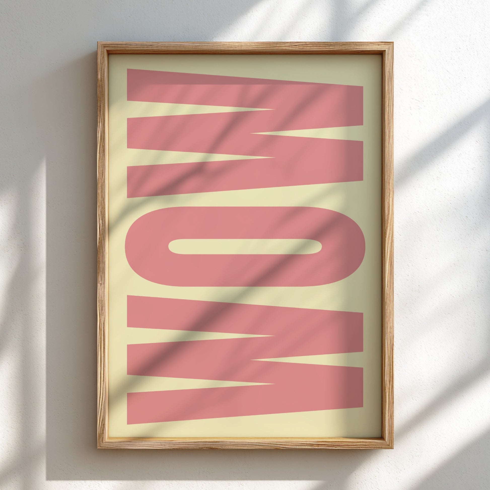 Framed artwork with the word 'WOW' in pink on a light background