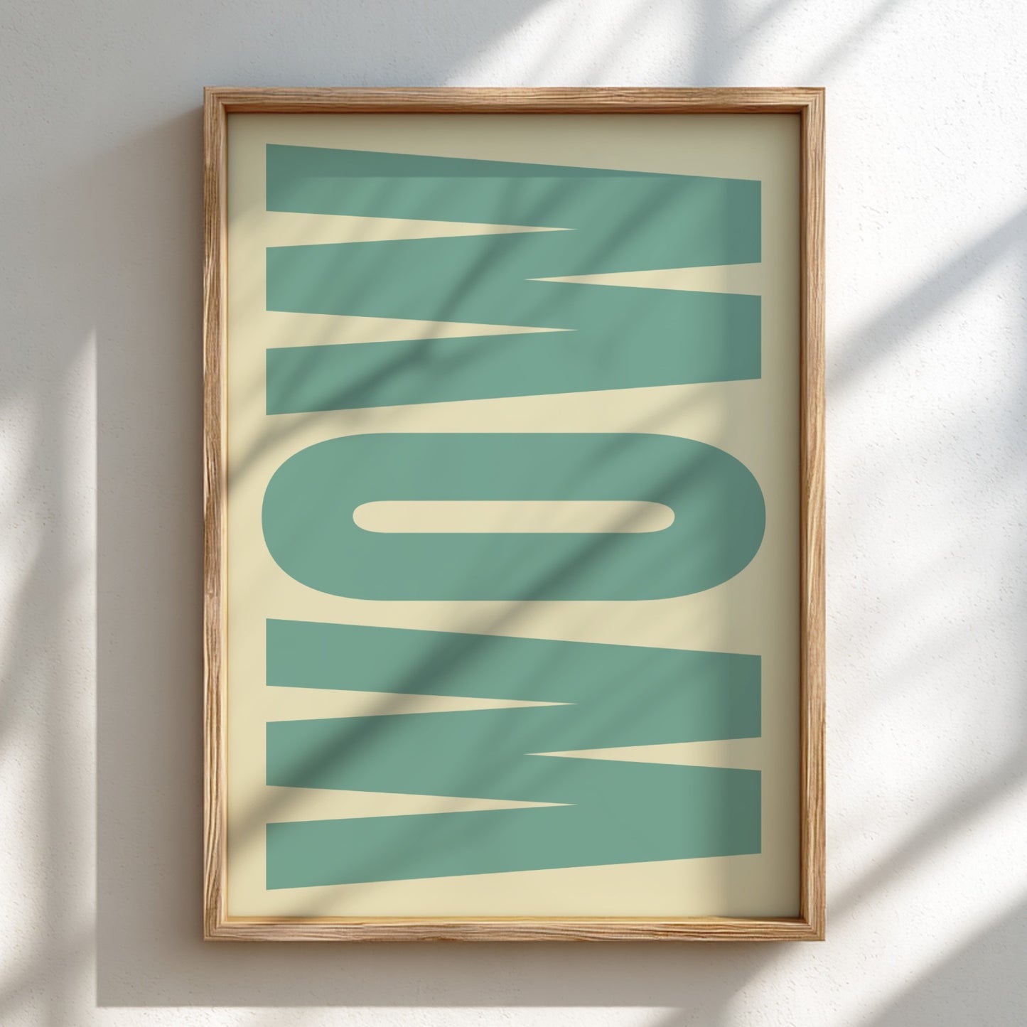 Framed artwork with the word 'WOW' in teal on a beige background