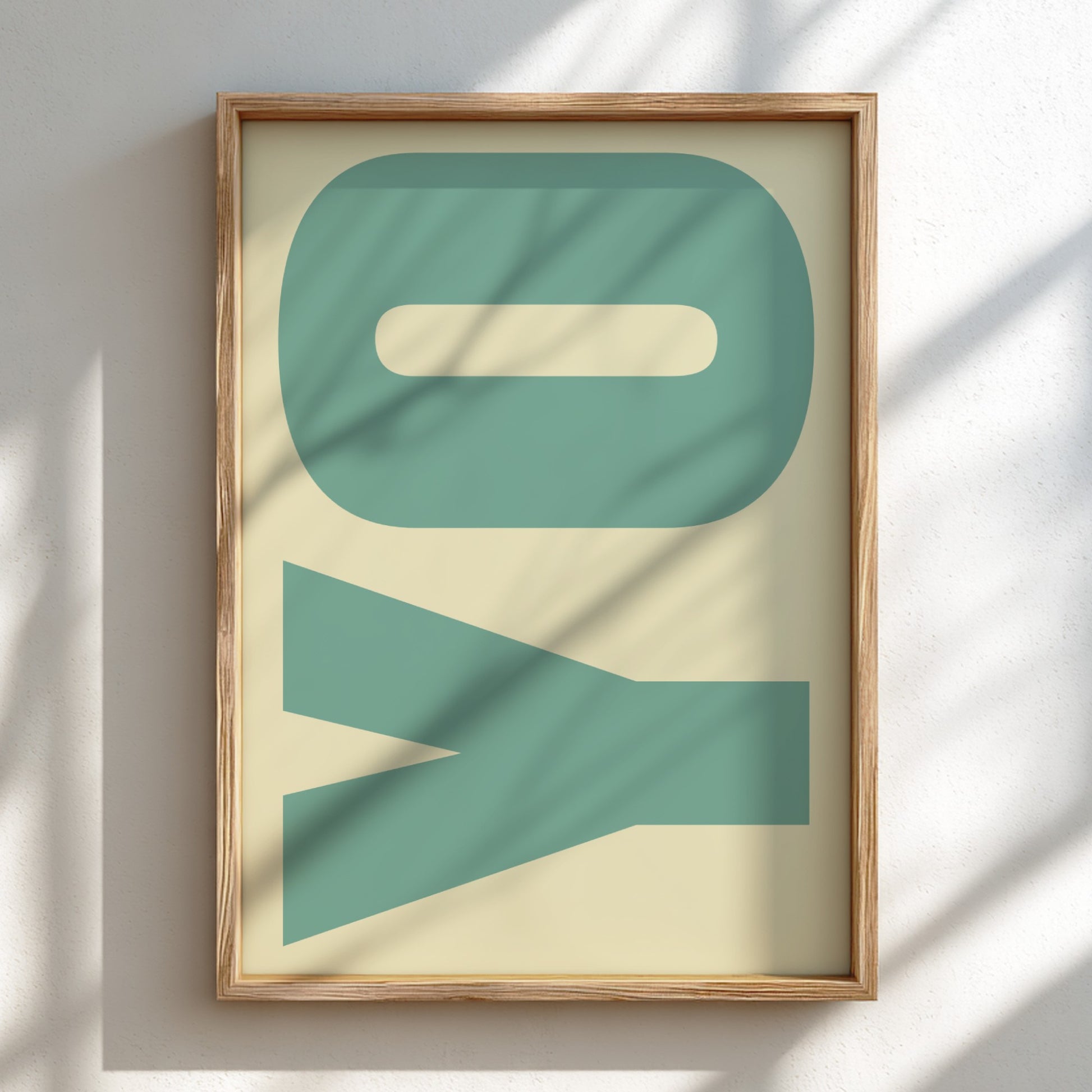 Framed artwork with 'YO' in teal on a beige background