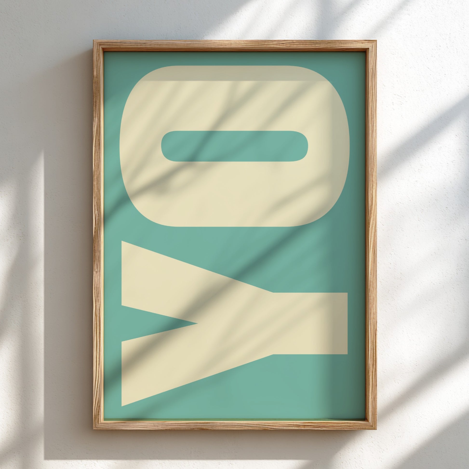 Framed artwork with 'YO' in large beige letters on a teal background