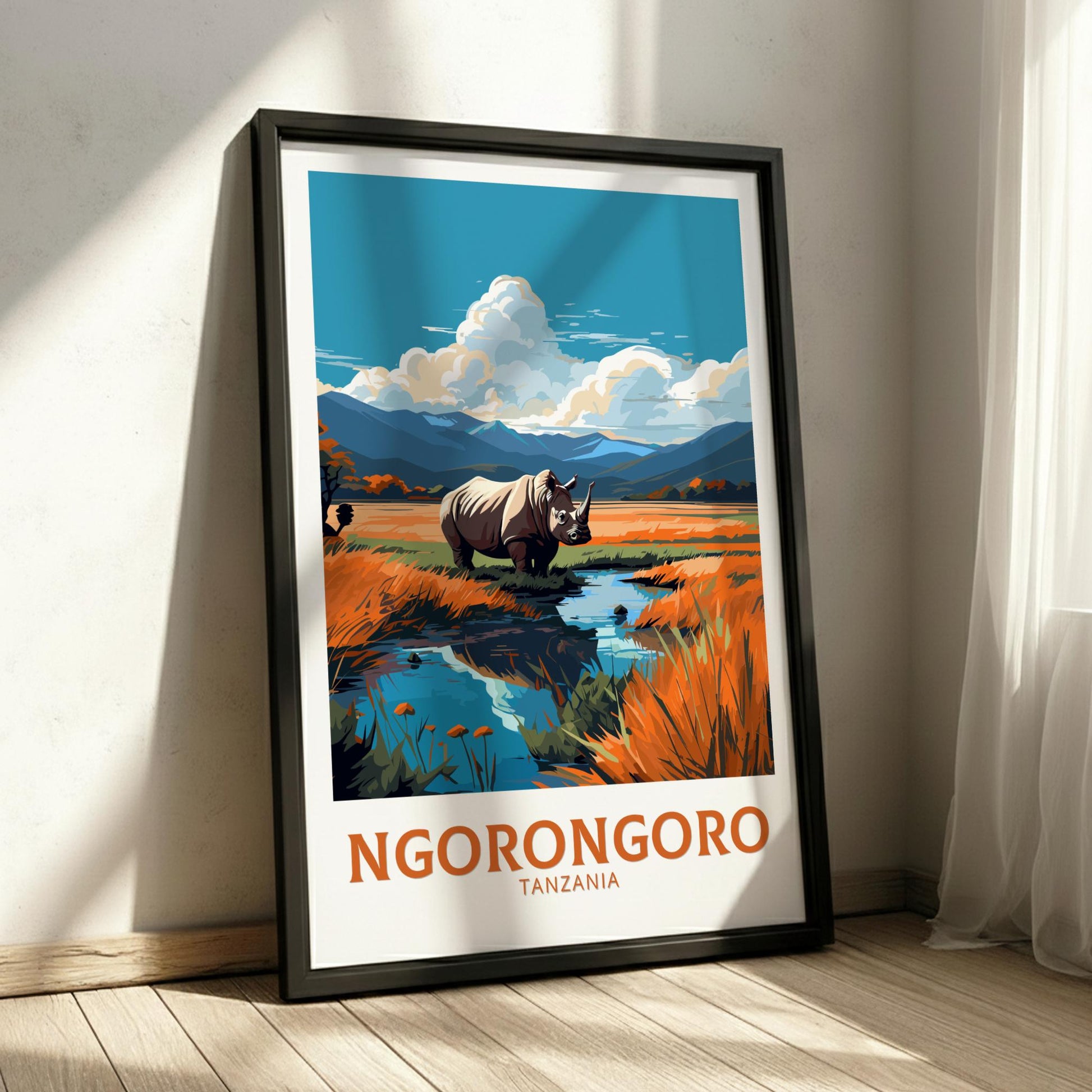 Framed poster of Ngorongoro Crater with a rhino and landscape, placed on a wooden floor.